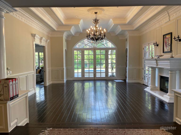  living room with fireplace facing back yard and fountain 