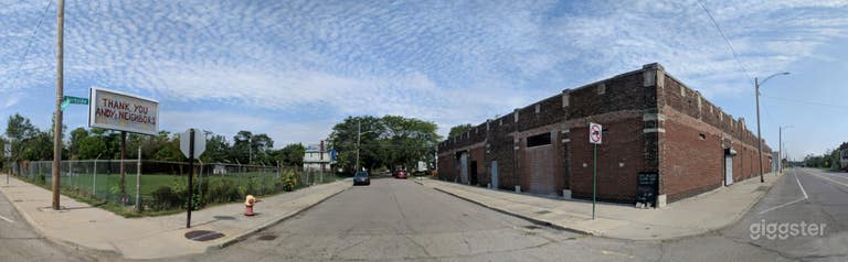  Building facade, fenced parking opposite side of street 