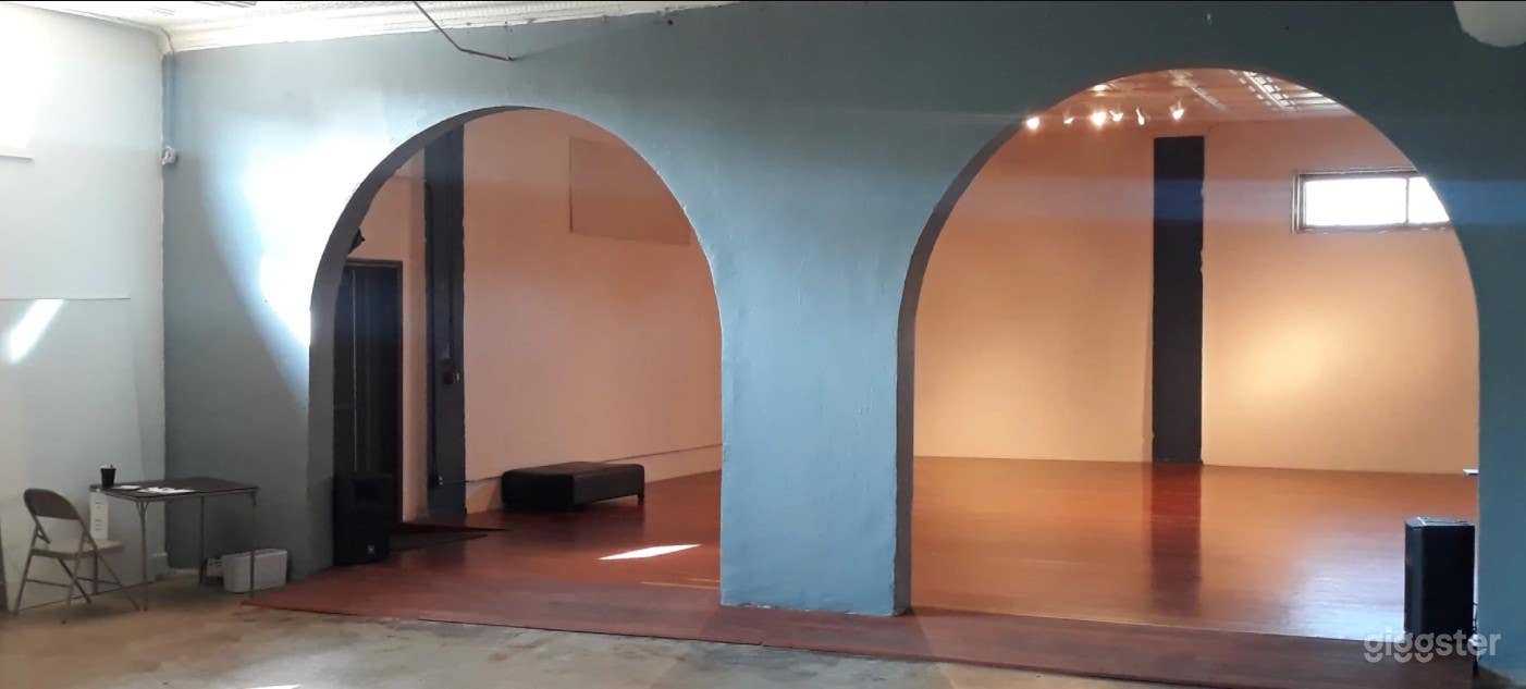 Arches divide studio and foyer; closed by curtain.