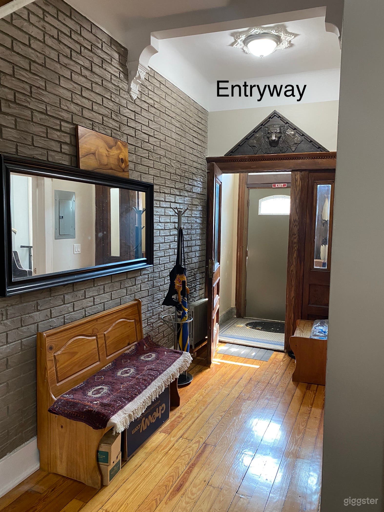 Entryway with original oak door and exposed brick wall