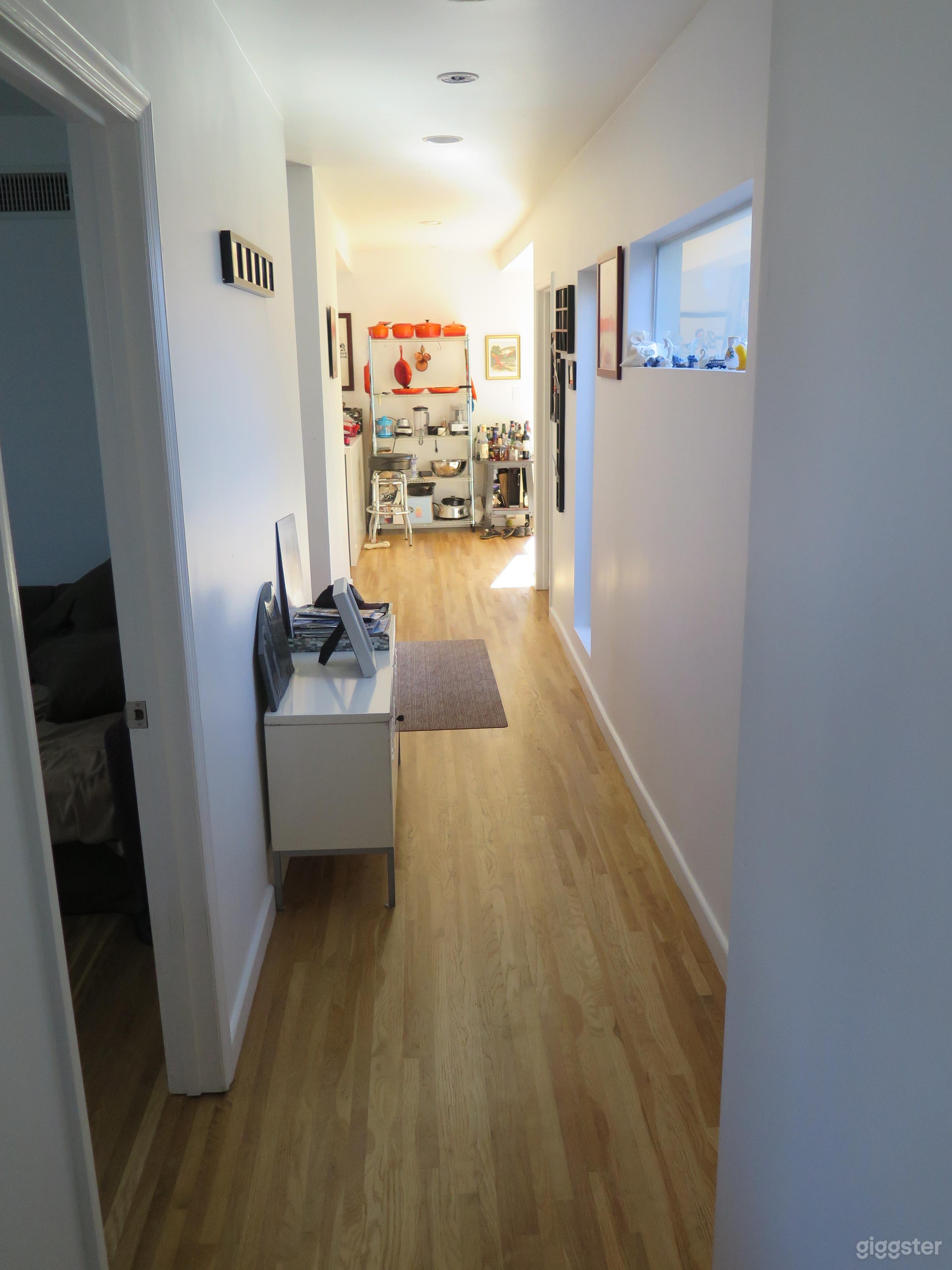 Slim hallway from living room to kitchen/dining room area.