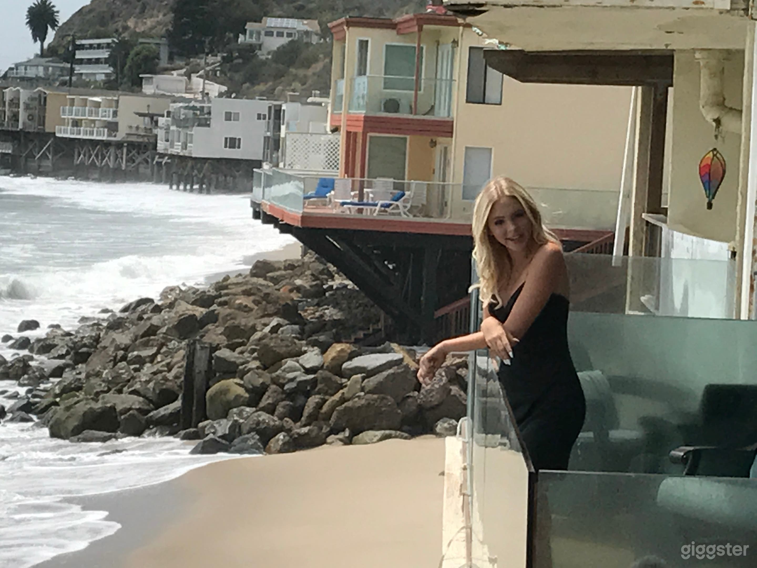 Famous Rock Star on deck with Ocean in background.