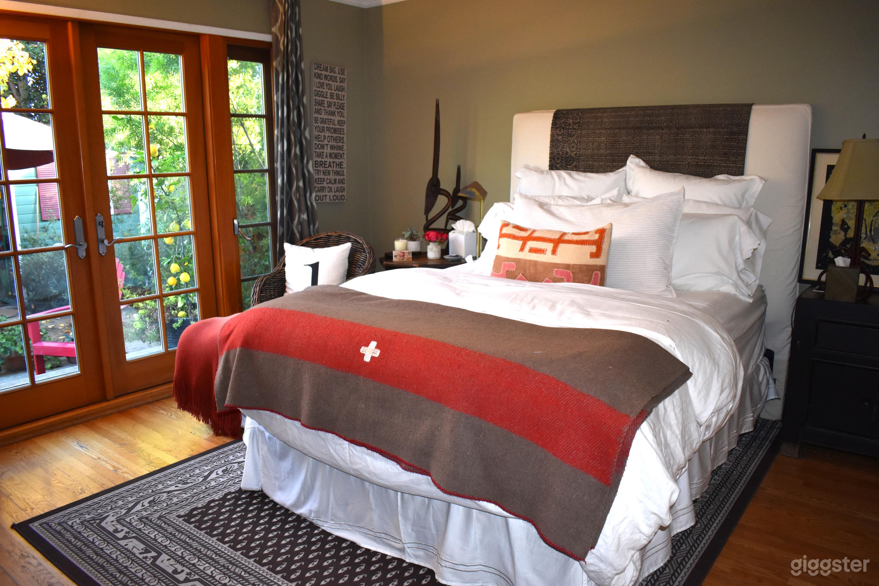 One of four bedrooms attached to ensuite,  opens on to back patio, with potted lemon trees, succulents and red adirondeck chair lounge
