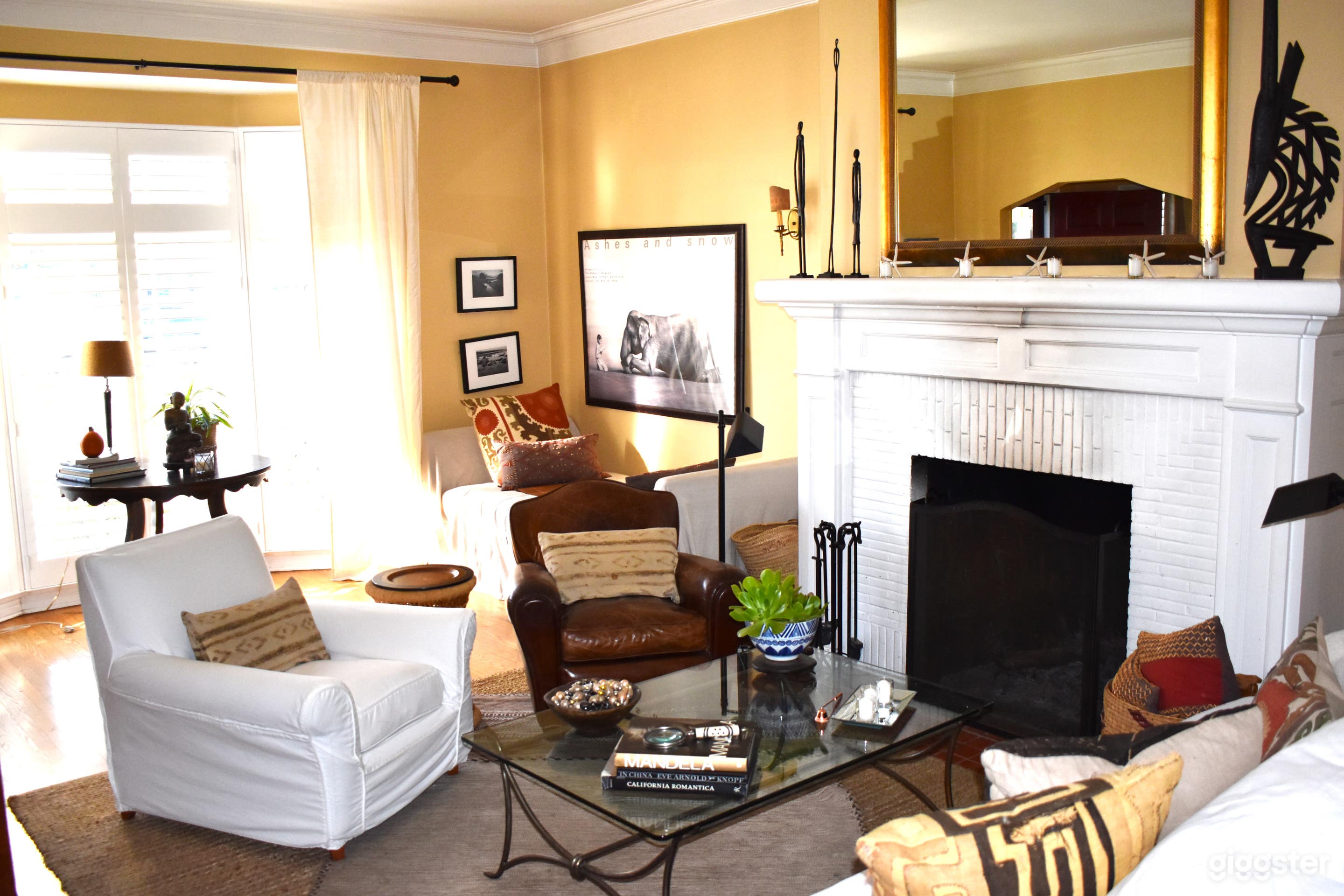 Livingroom, 10 ft. ceilings, working wood burning fireplace, floor to ceiling front facing windows and entrance to side patio