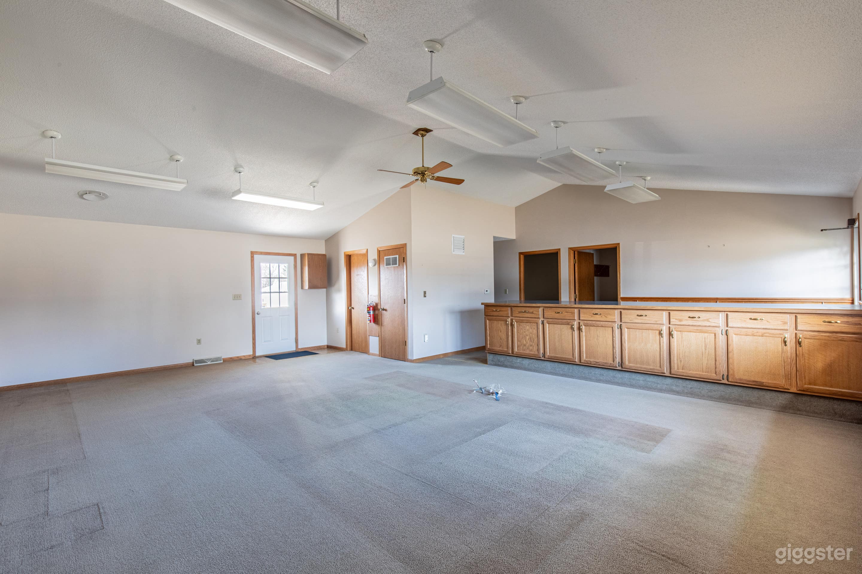 Large open space viewing the front door, bathroom and utility room door. 