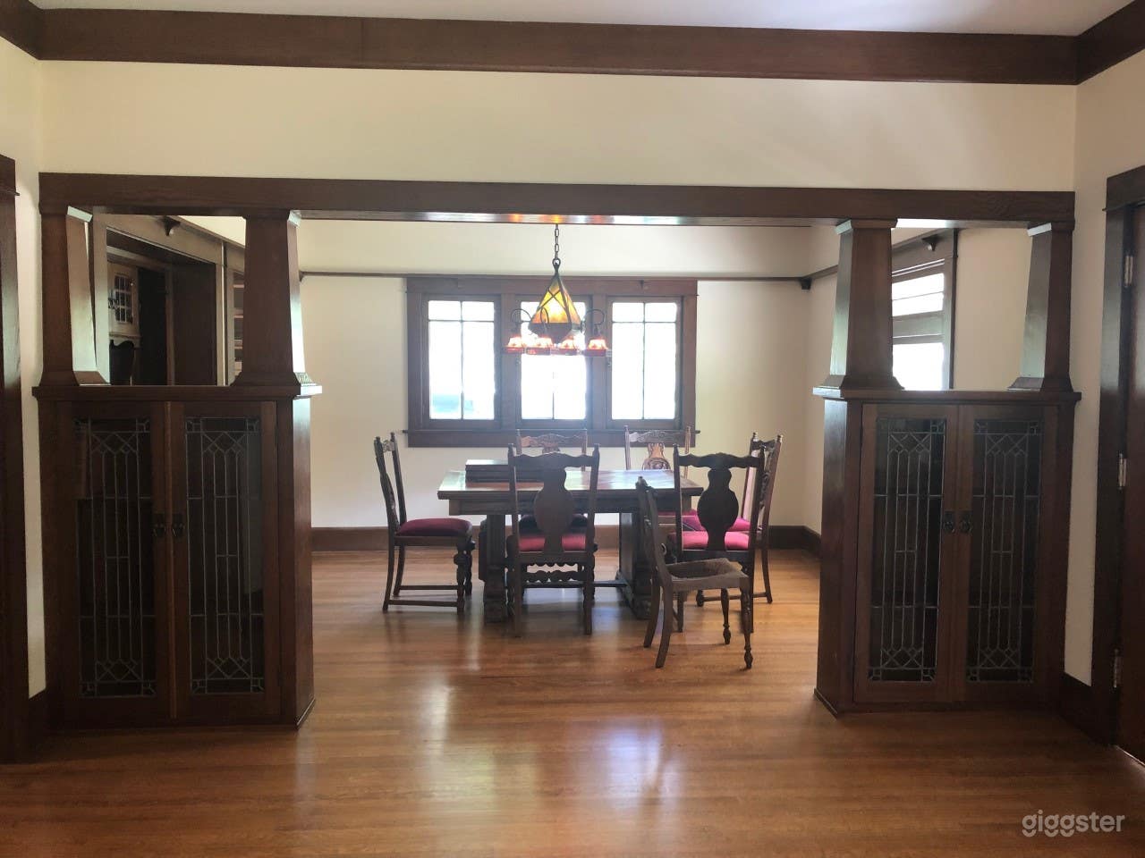Dining room with cabinets and chandelier.