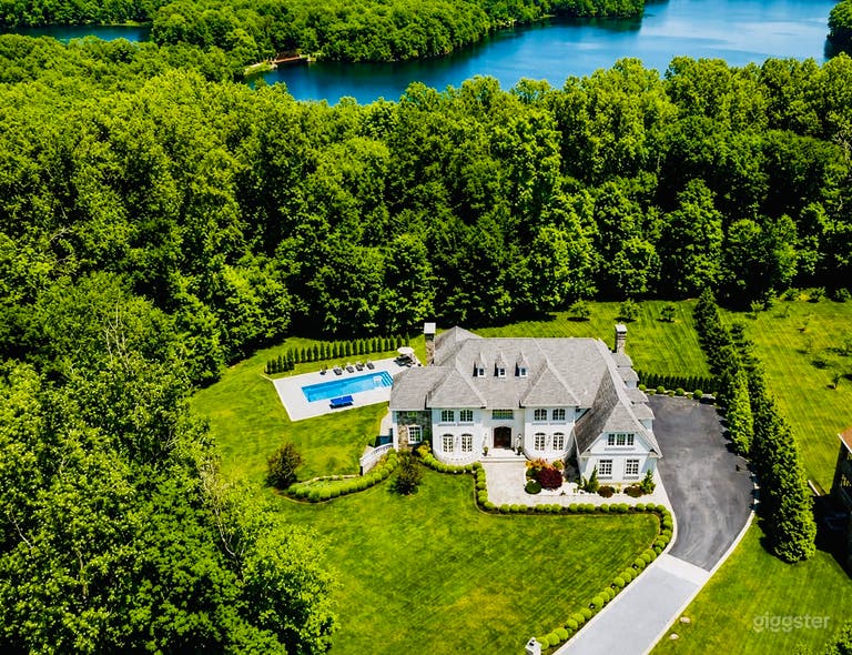  Private luxury estate on 2 acres with pool, manicured grounds, circular driveway, and lake views. Ideal for films, commercials, lifestyle shoots, and branded content. 