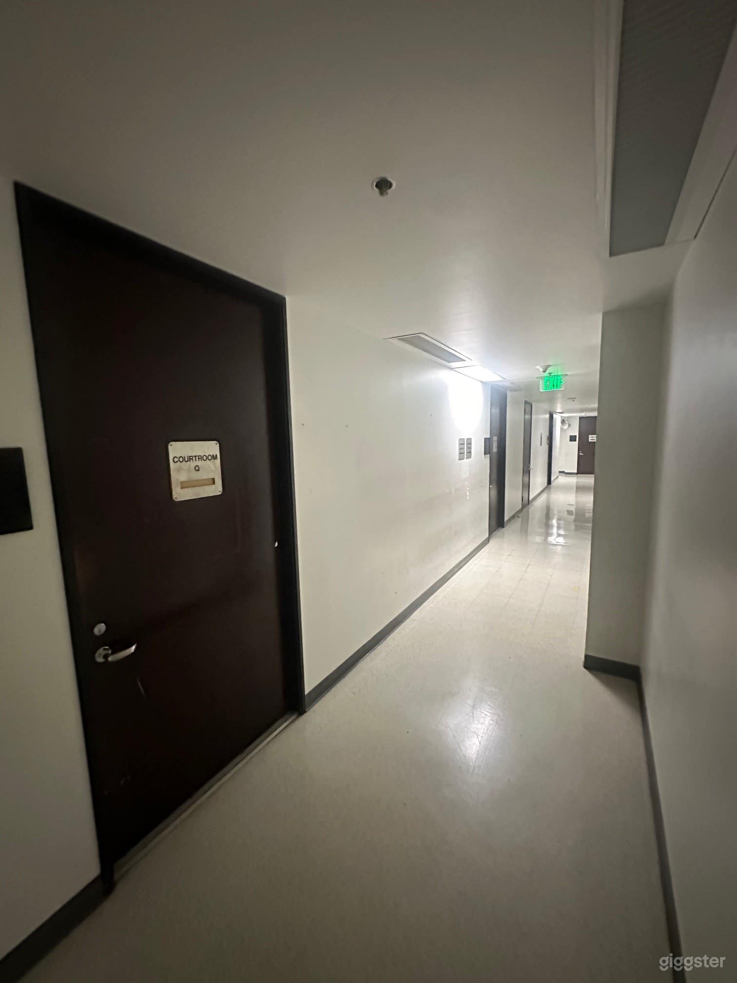 Spacious Vacated Courtroom with Long Hallways Photo 4