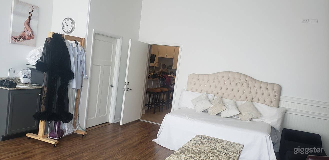 Door on the left leads to the bathroom. Open door leads to the loft area