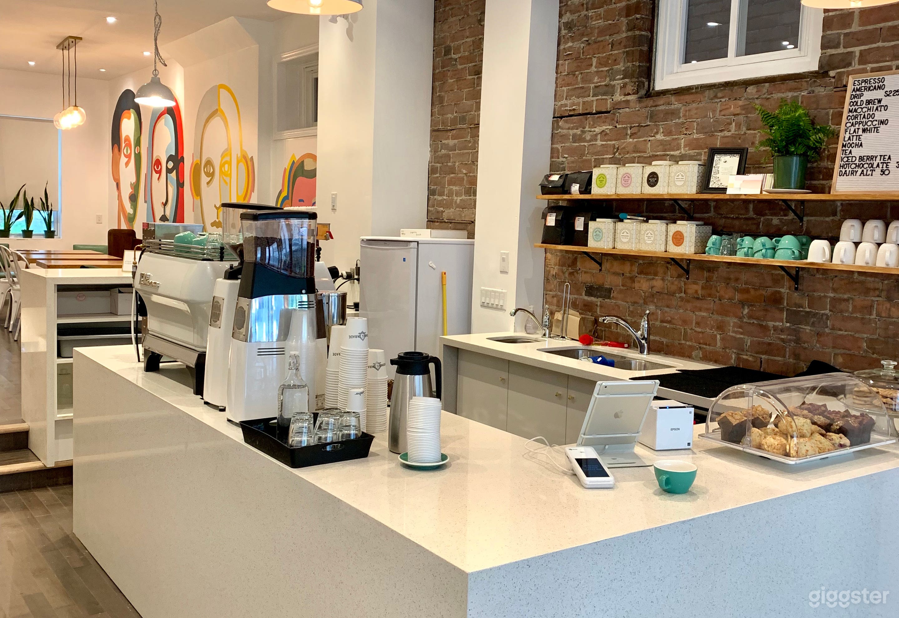 Bright Modern Cafe with Vibrant Murals and Patio Photo 1