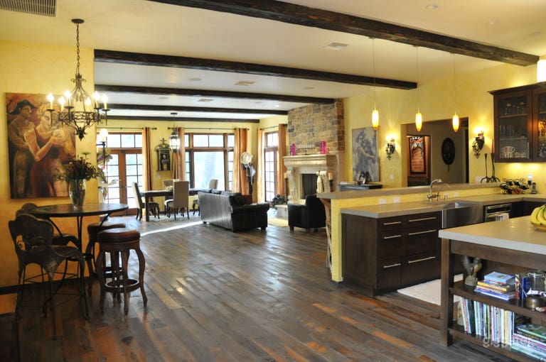  The great room is the center of the ranch.  Reclaimed wood floors, a fireplace, lots of natural light and beamed ceilings 