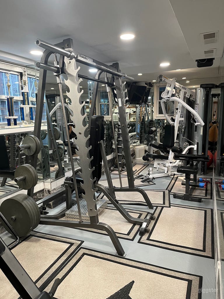  Gym showing squat rack and equipment  