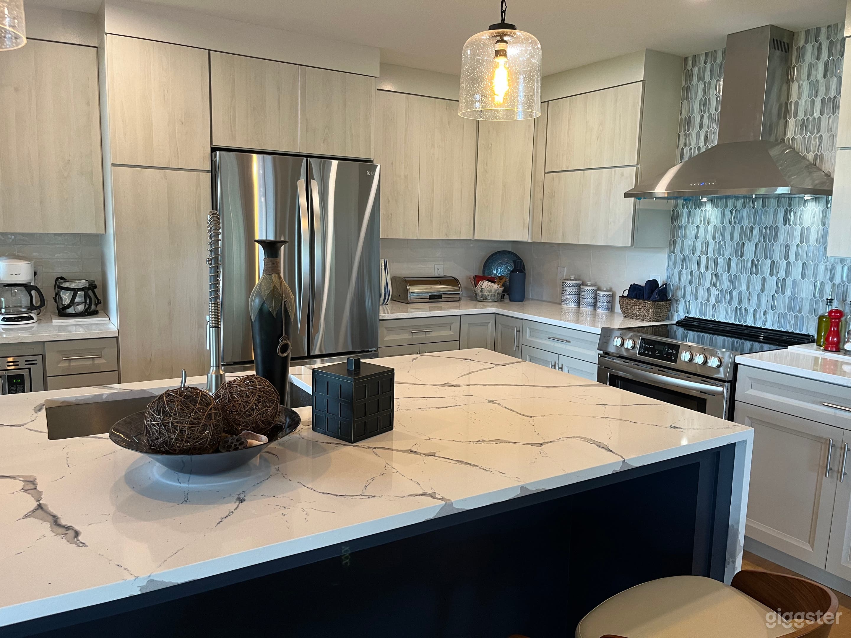 Partial view of open kitchen with new stainless appliance and quartz countertops