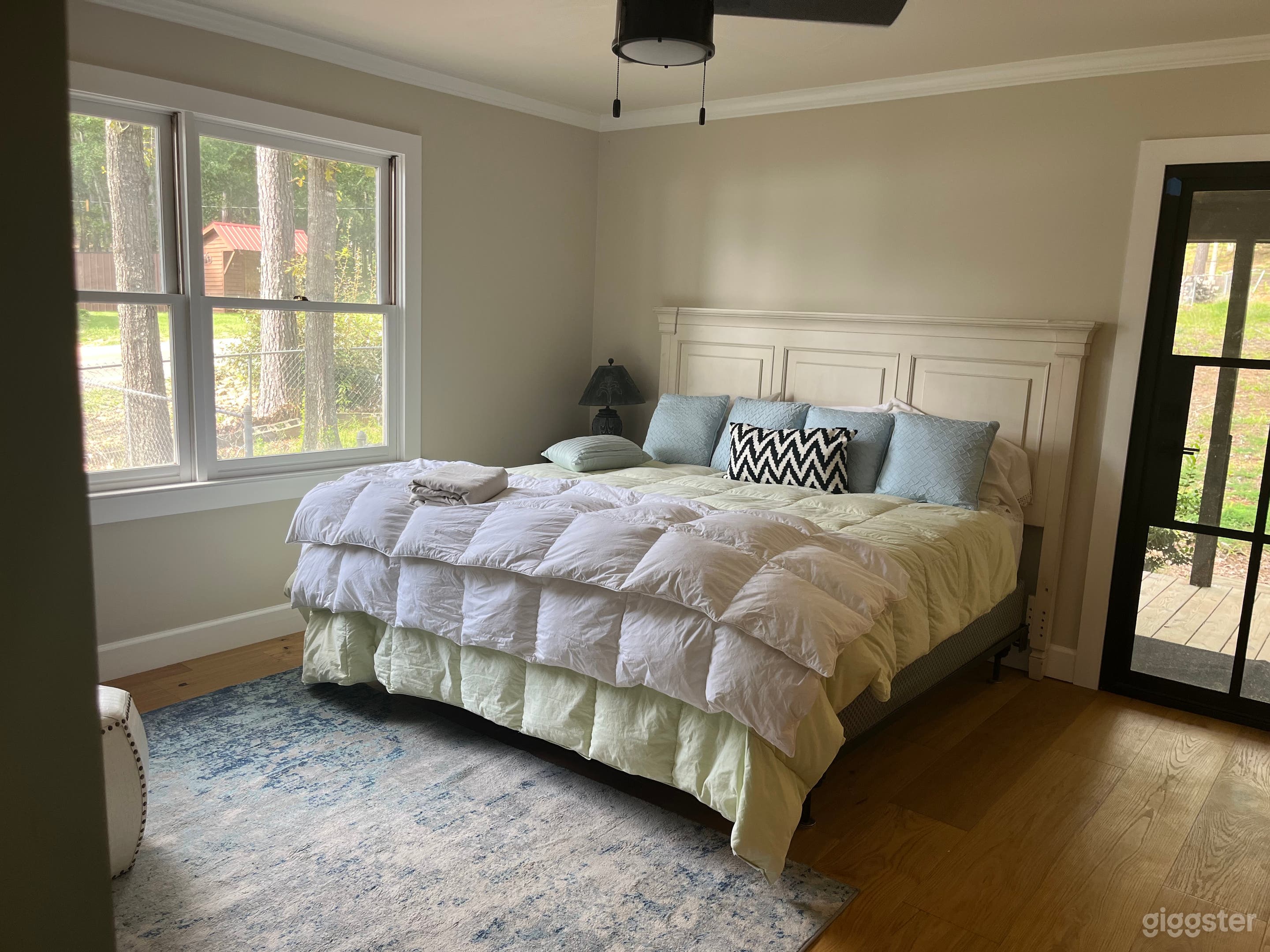 Master bedroom with king size bed and wooden floors