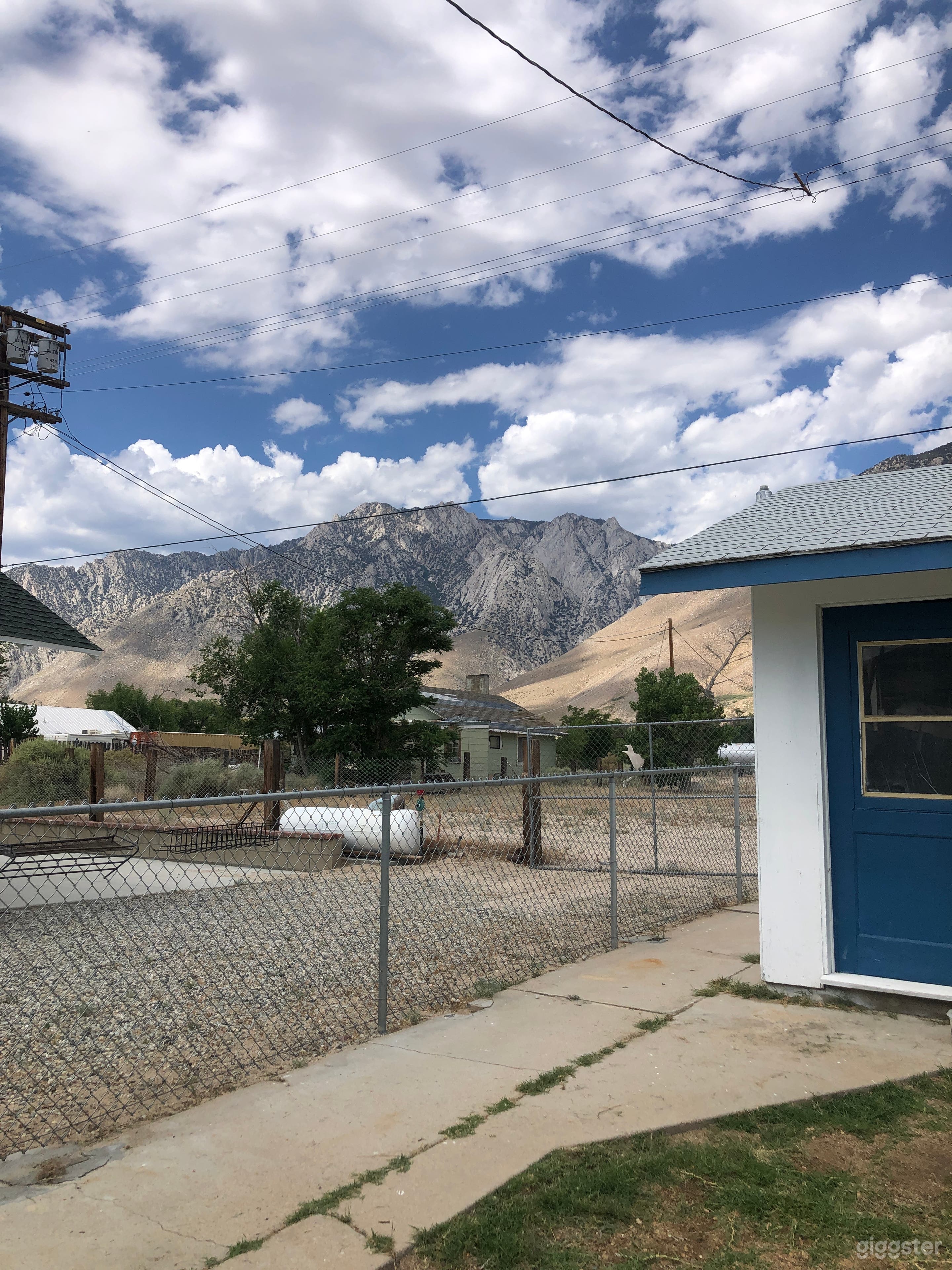 back yard view of mountains partial view of garage.