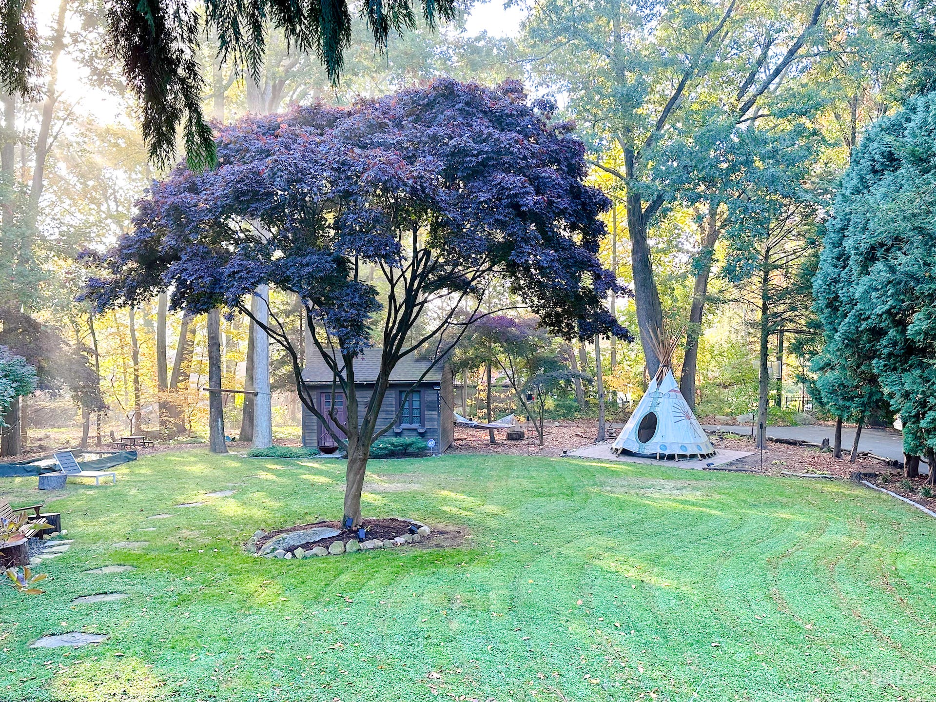 Side yard view.  Authentic Native American teepee too !

