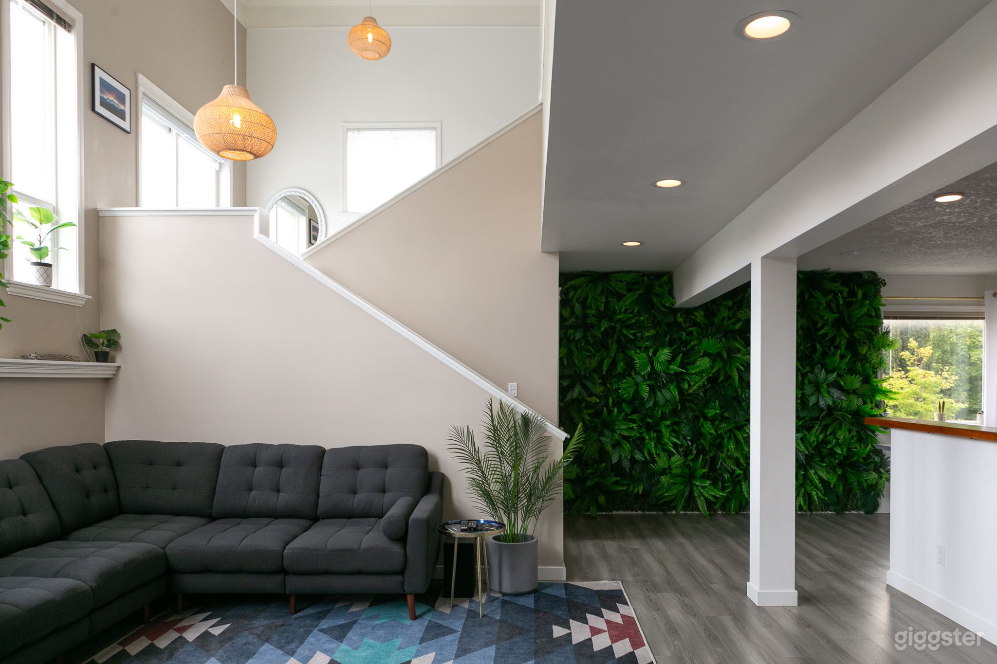 side view of living room and faux plant wall