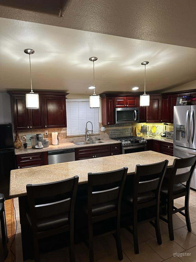 Fully function open kitchen with large island and stainless steel appliances