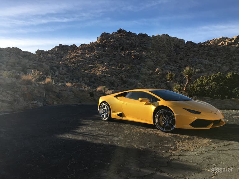  Vehicle parked near south side of residential structure&#x27;s 
attached garage.  Shows paved drive. Property in view is part of the 20 acres of site. 