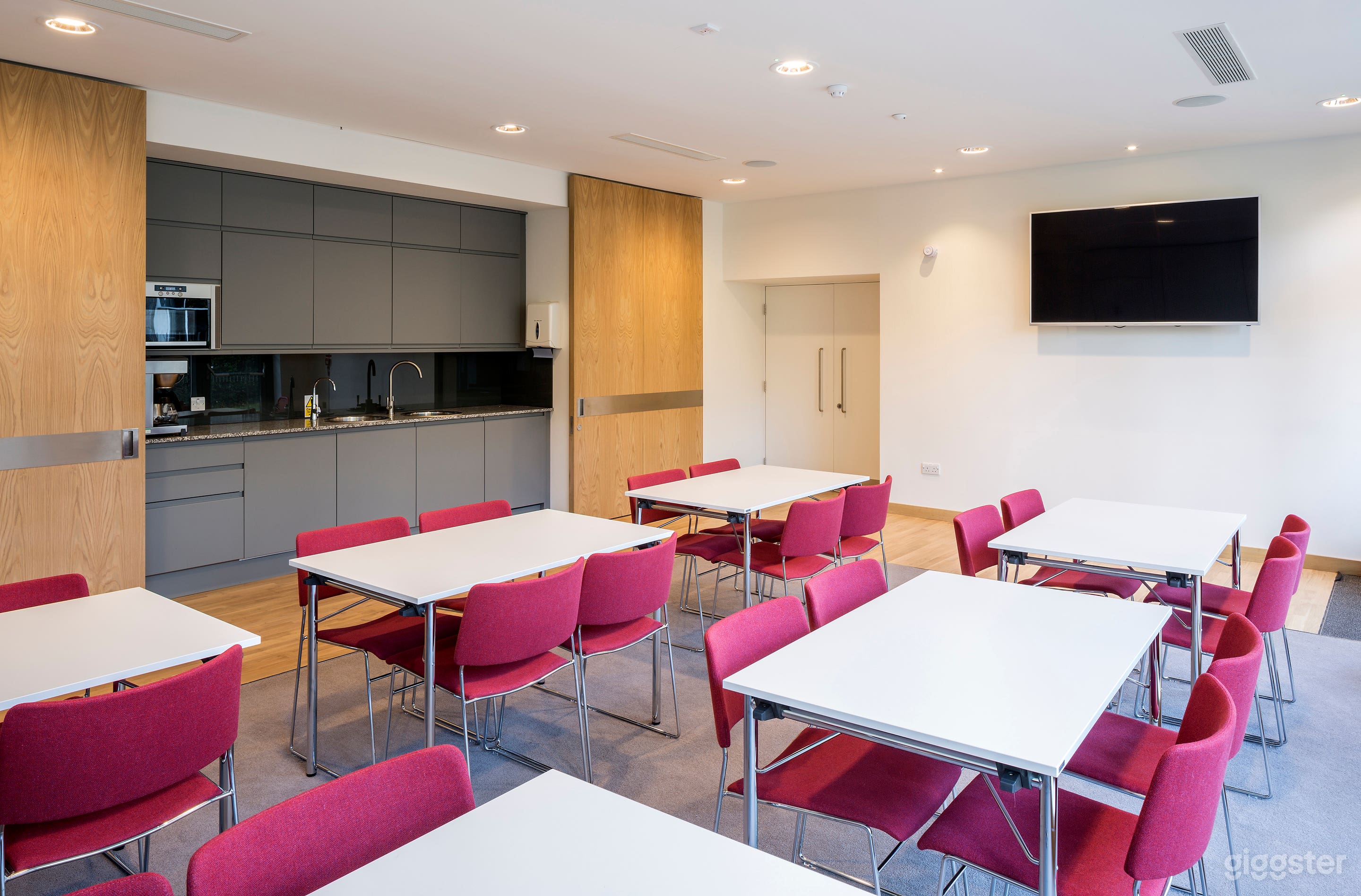 Garden Room with kitchenette. Sliding wooden doors can be shut to conceal the kitchenette. Room set up in coffee house style.
