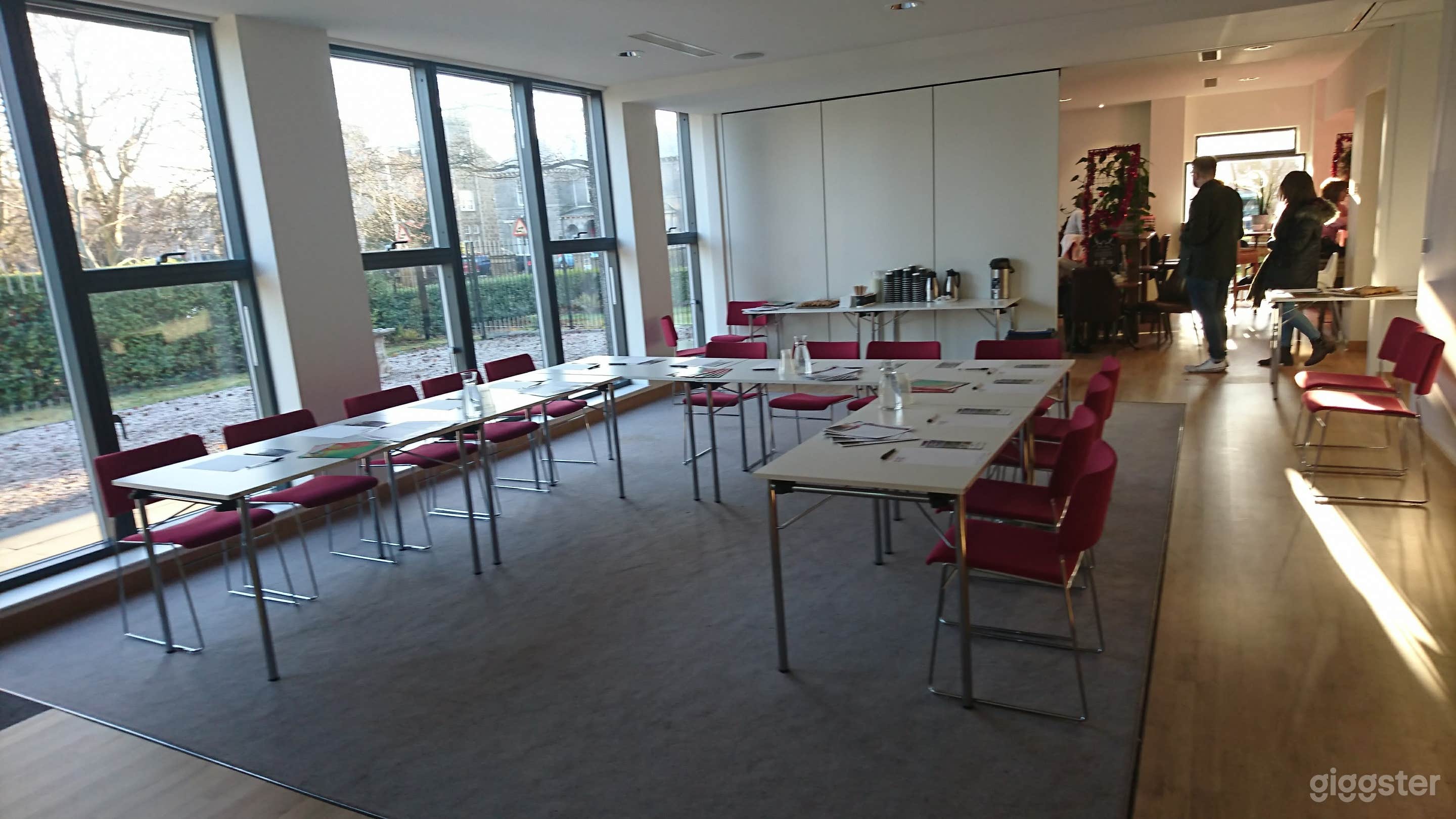 Garden Room set up in conference style, with part of the removable wall connecting to the coffee house off. 