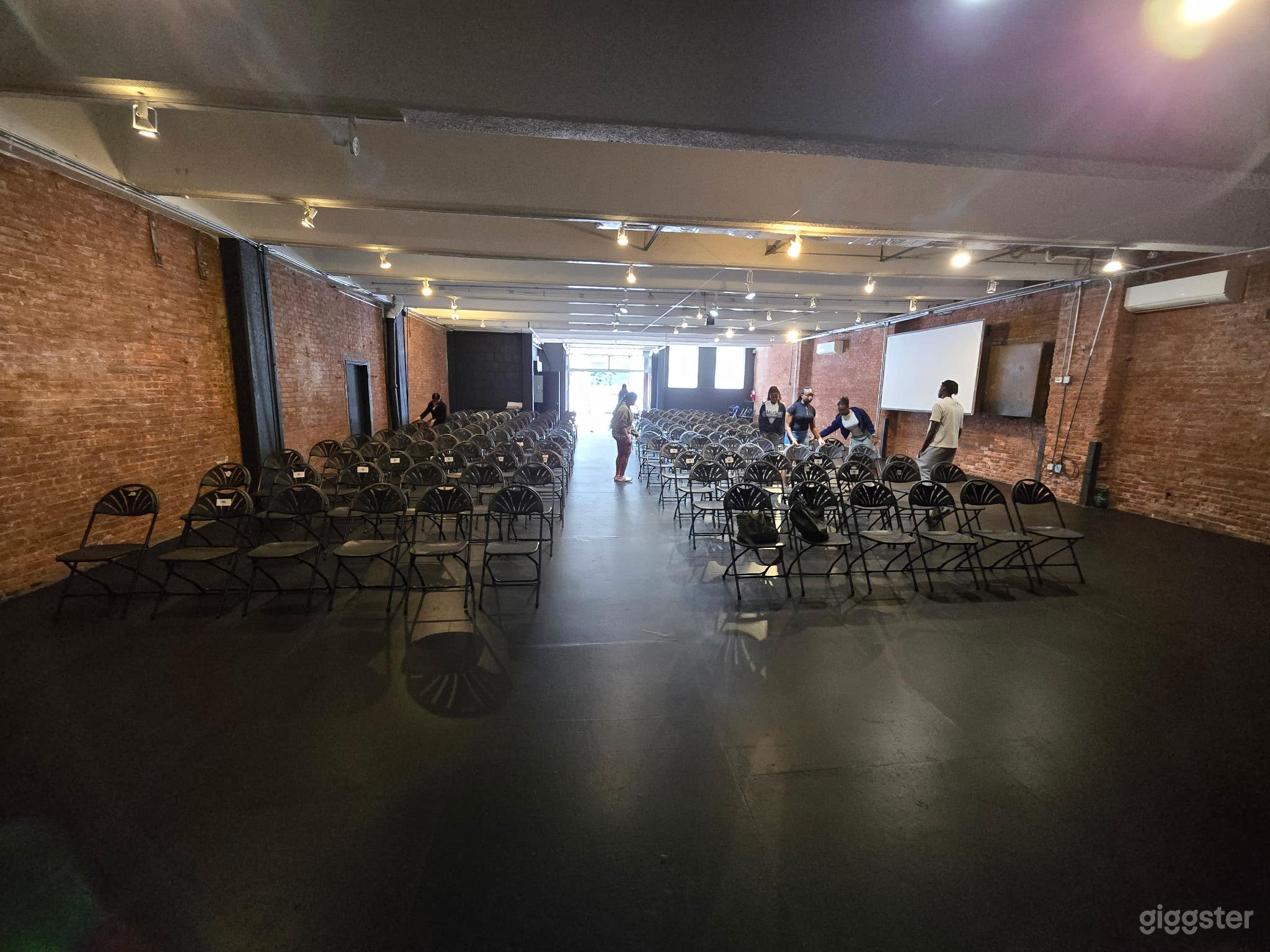 Basic black! Studio one features exposed brick a glass and metal roll up gate to bring in the outdoors and black floors. It's the perfect venue for meetings, fund raisers, and social events!