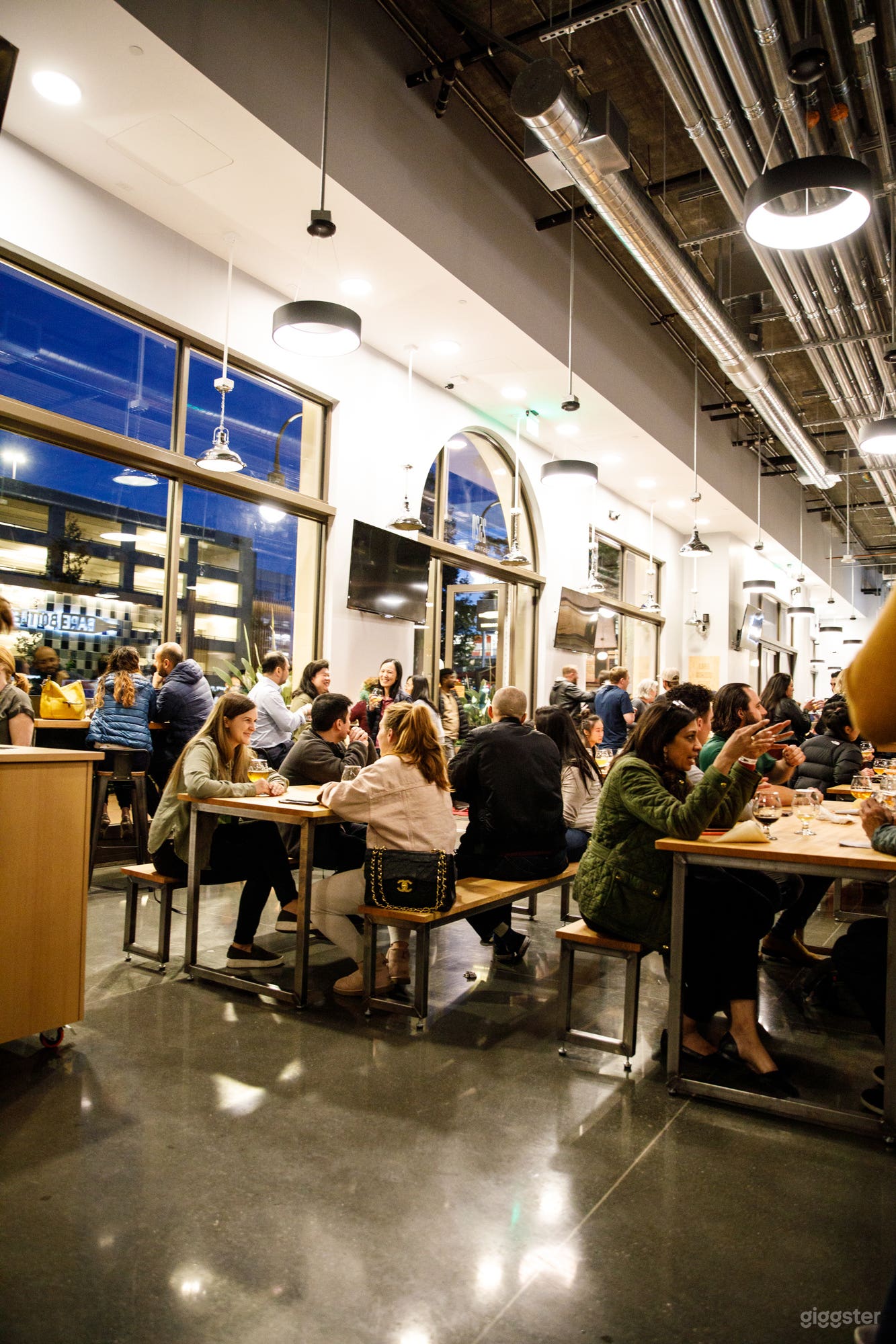 Large windows and picnic table seating.