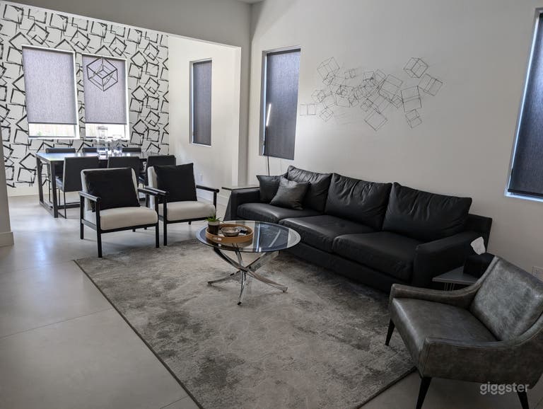  Open floor plan makes the entire first floor living space flow from one room to the next. First floor has oversized 4 ft x 4 ft grey concrete tiles for flooring, and the 3-D cube art over the sofa mirrors dining room wallpaper and light fixture. 