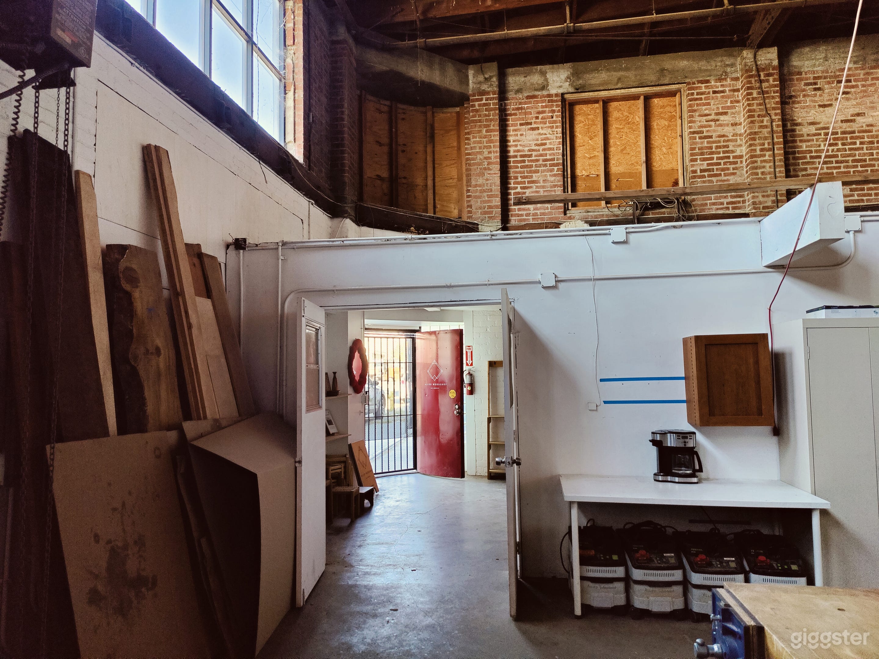 Woodshop with exposed brick and trussed roof Photo 4