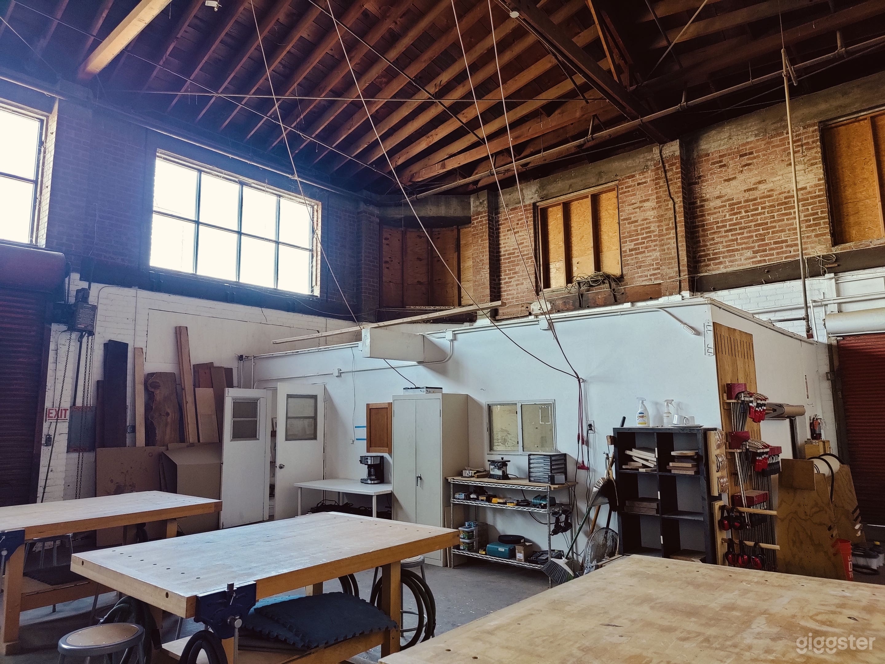 Woodshop with exposed brick and trussed roof Photo 3