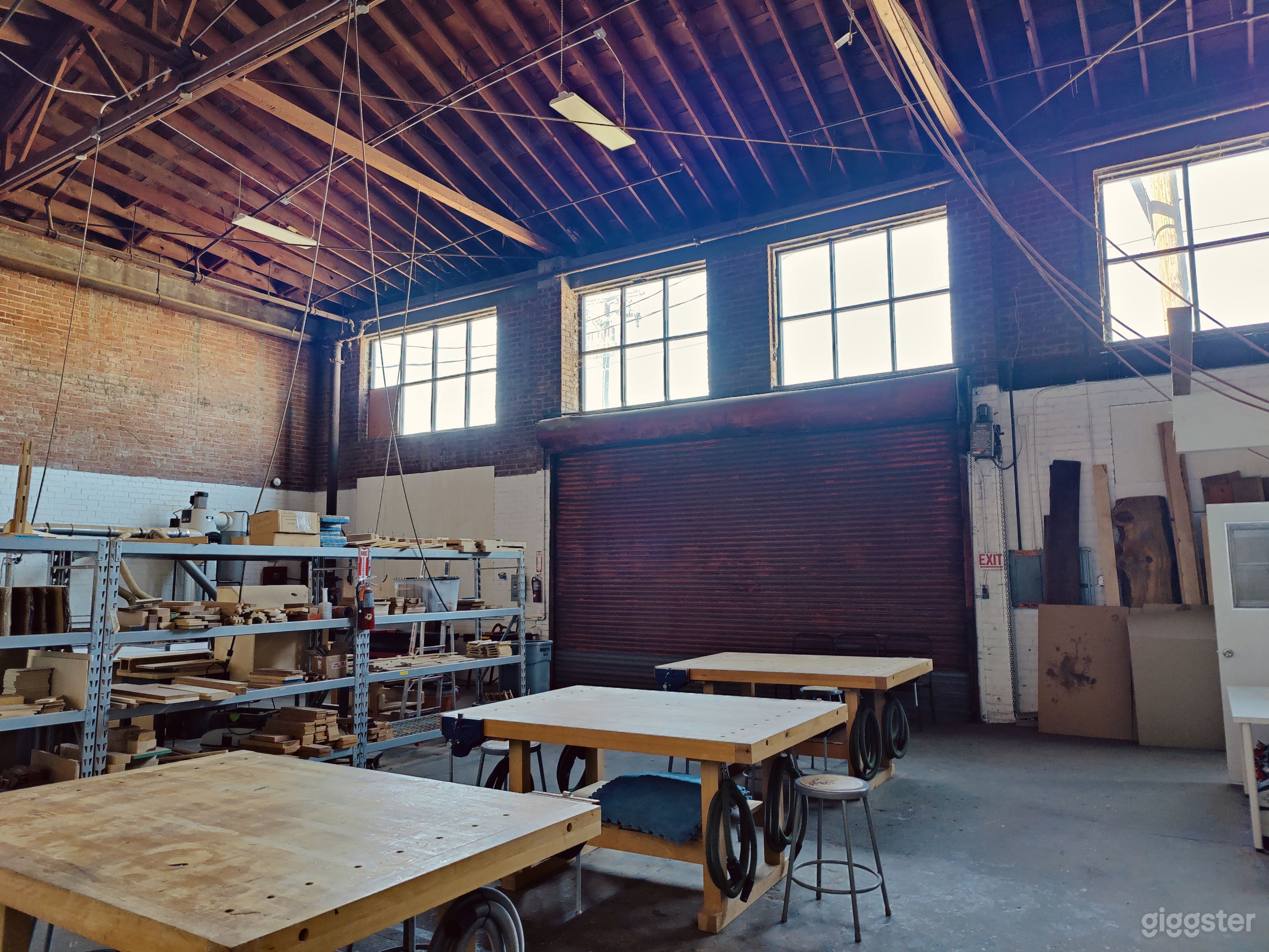 Woodshop with exposed brick and trussed roof Photo 1