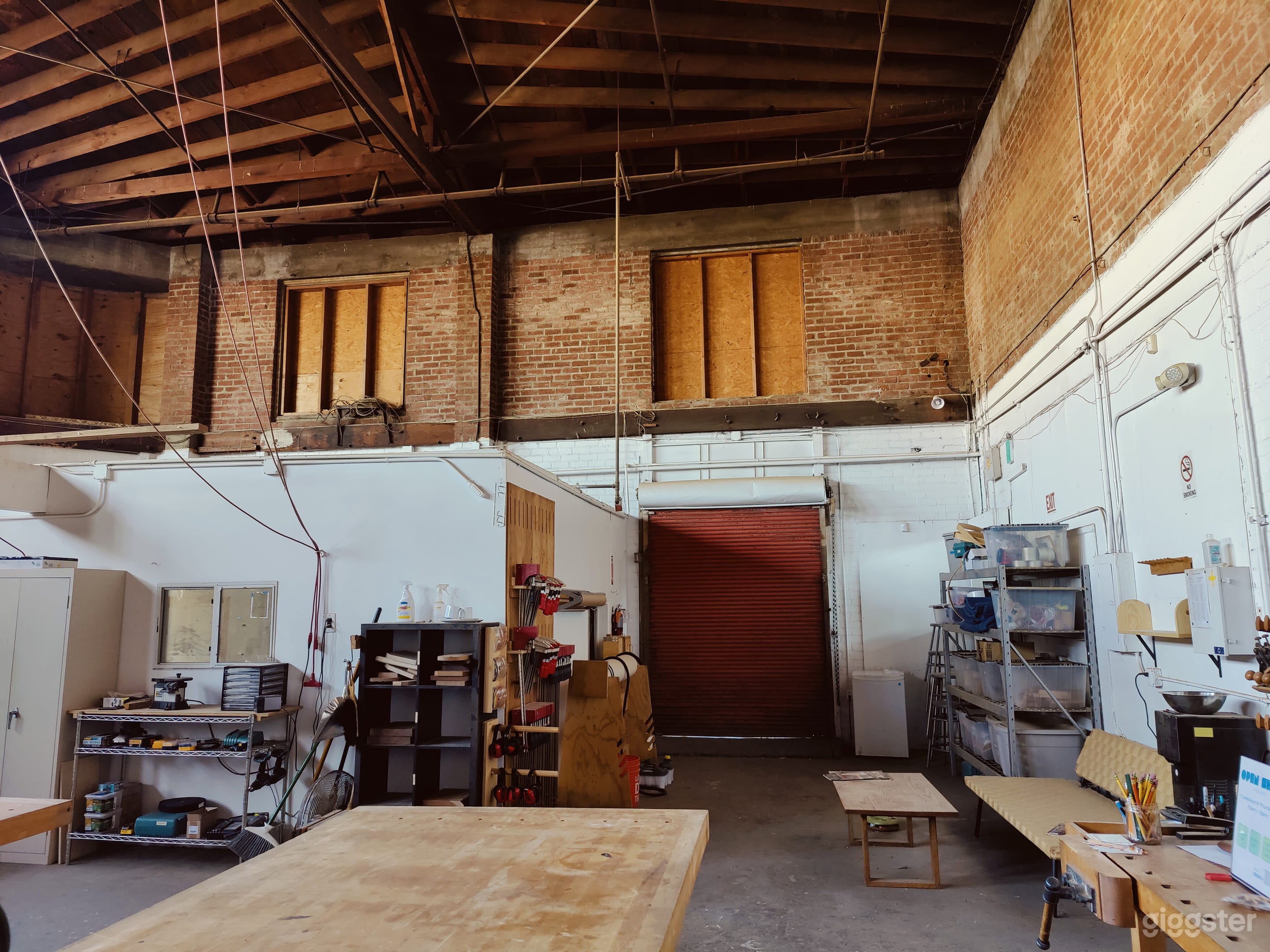 Woodshop with exposed brick and trussed roof Photo 2