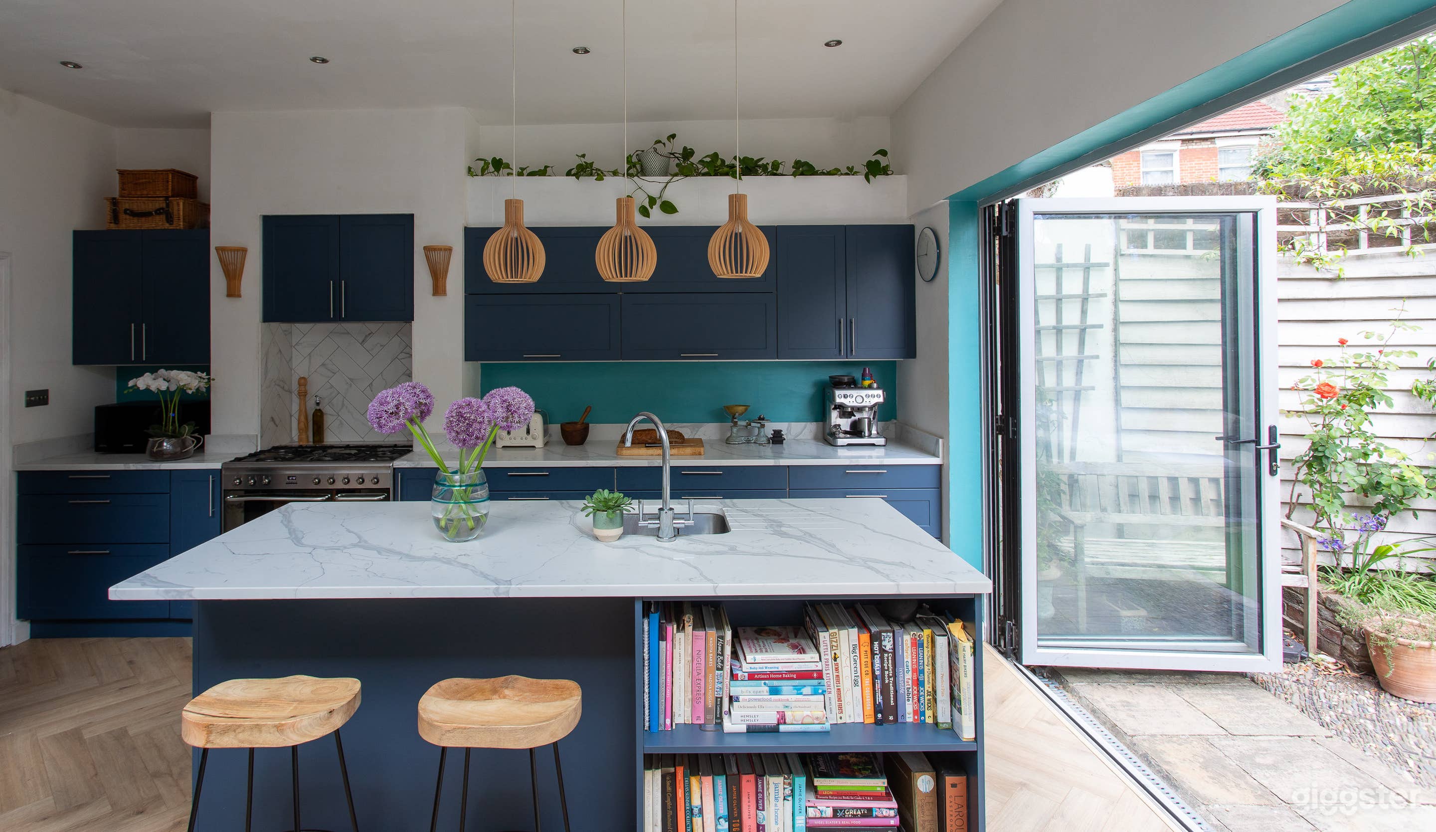 Kitchen with breakfast bar and doors open to patio garden