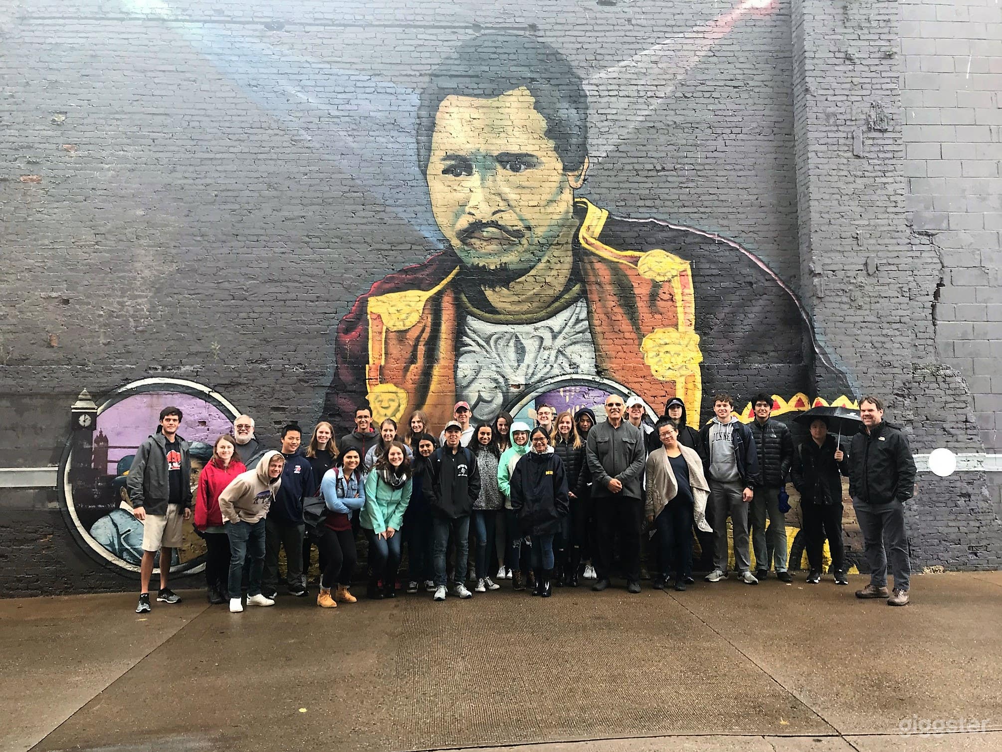 Tourist visiting Paul Robeson mural on side wall of arts studio building. This Paul Robeson mural is the 144'x 33'and is the largest mural in the world dedicated to the life of the world's 1st international superstar. Great backdrop for photo/video shoots 