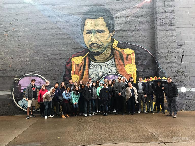  Tourist visiting Paul Robeson mural on side wall of arts studio building. This Paul Robeson mural is the 144&#x27;x 33&#x27;and is the largest mural in the world dedicated to the life of the world&#x27;s 1st international superstar. Great backdrop for photo/video shoots  