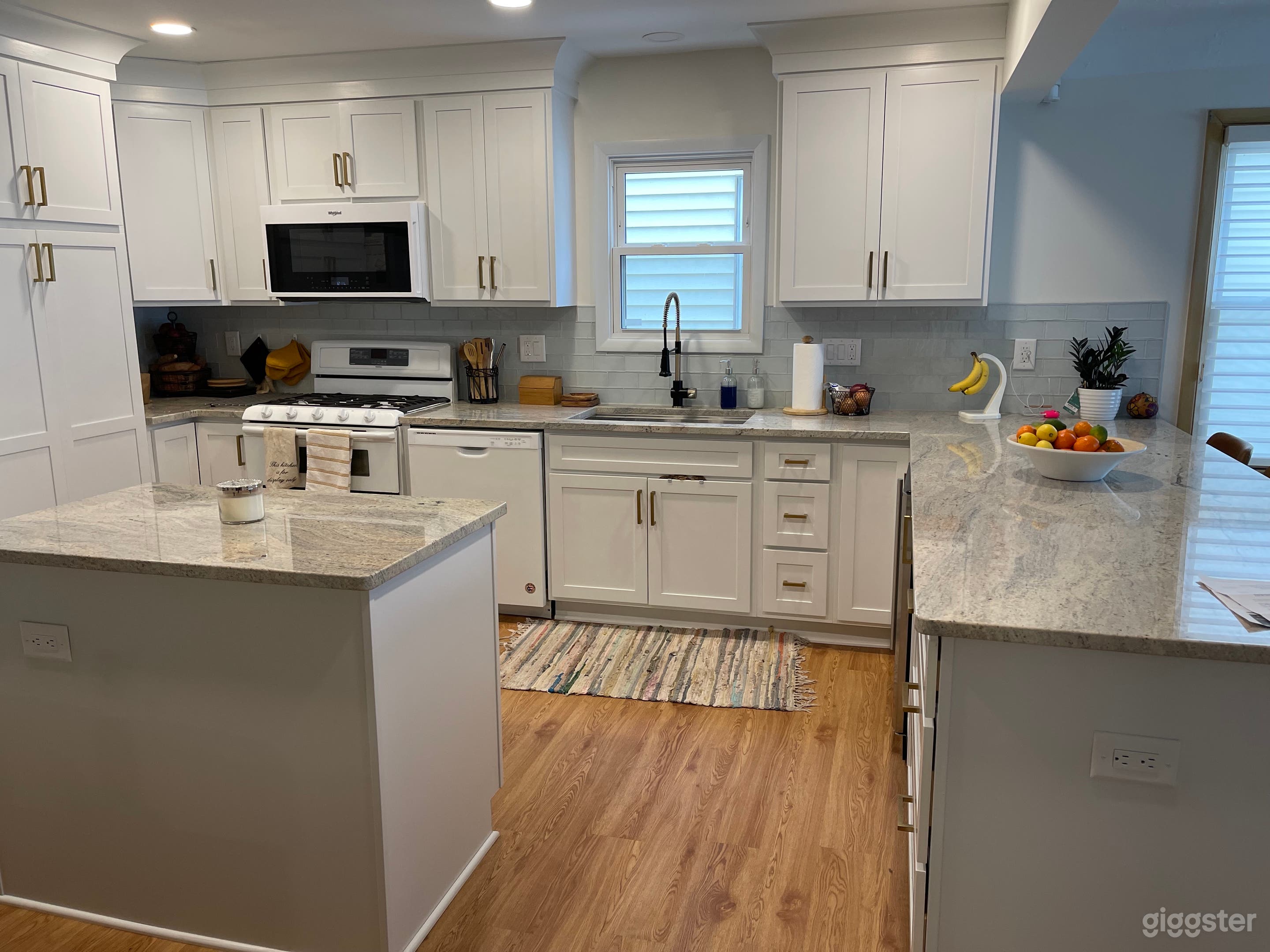White kitchen w/ granite countertops.
