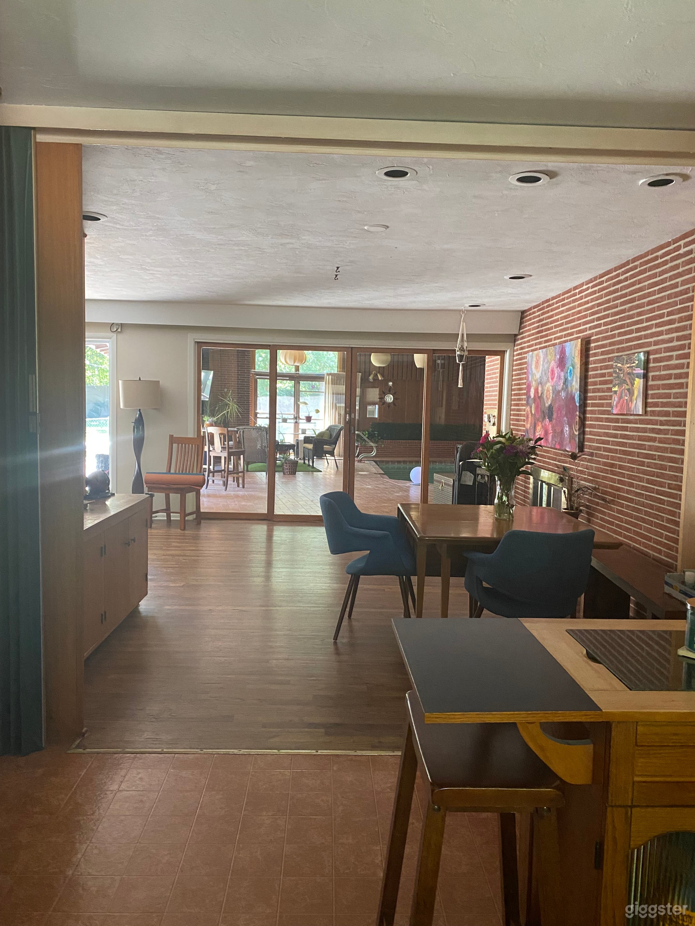 View from kitchen to dinning and pool room. Vinyl curtain that can be closed to separate