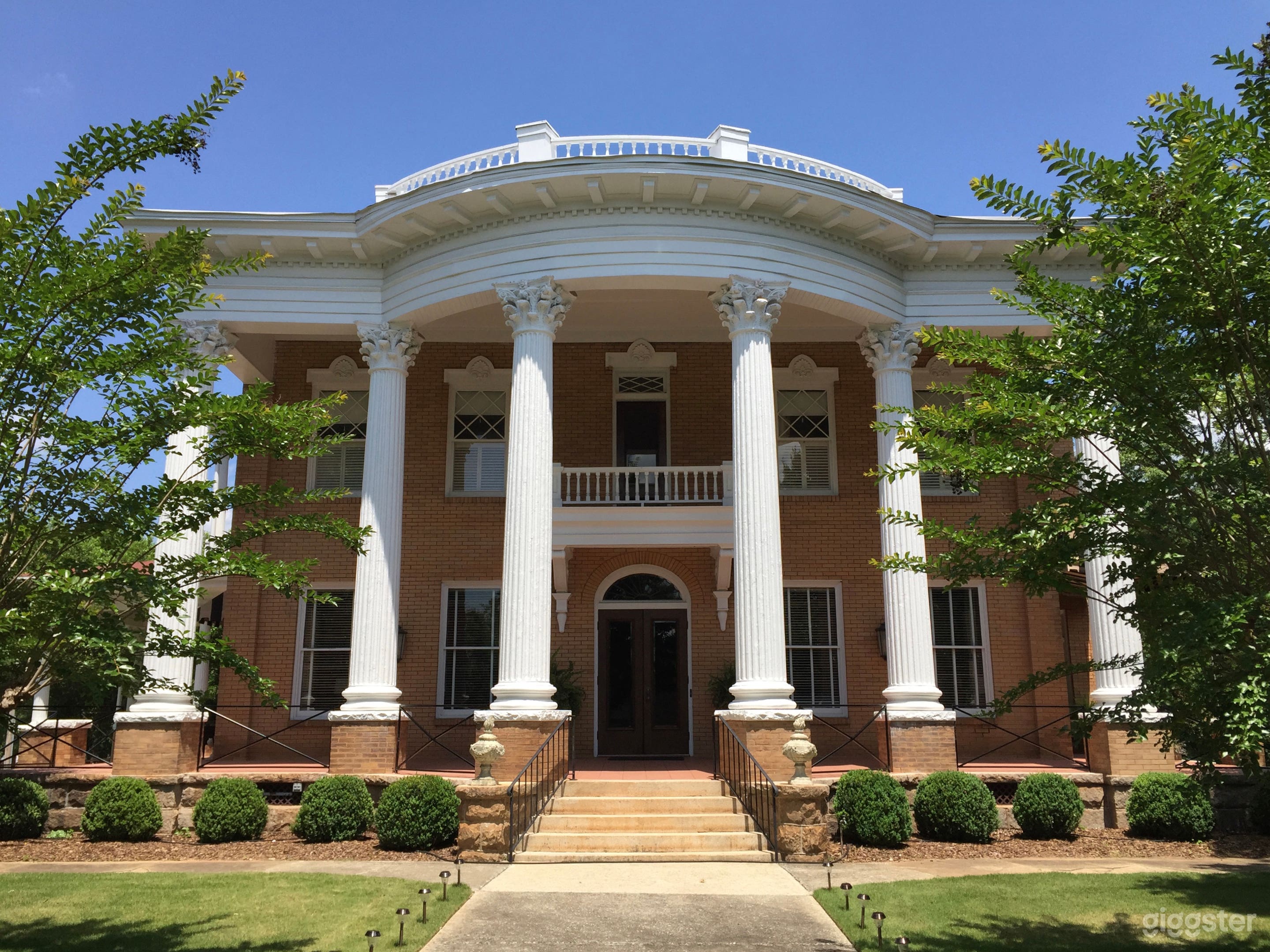 Front of building, featuring six massive concrete columns in the neoclassical style.