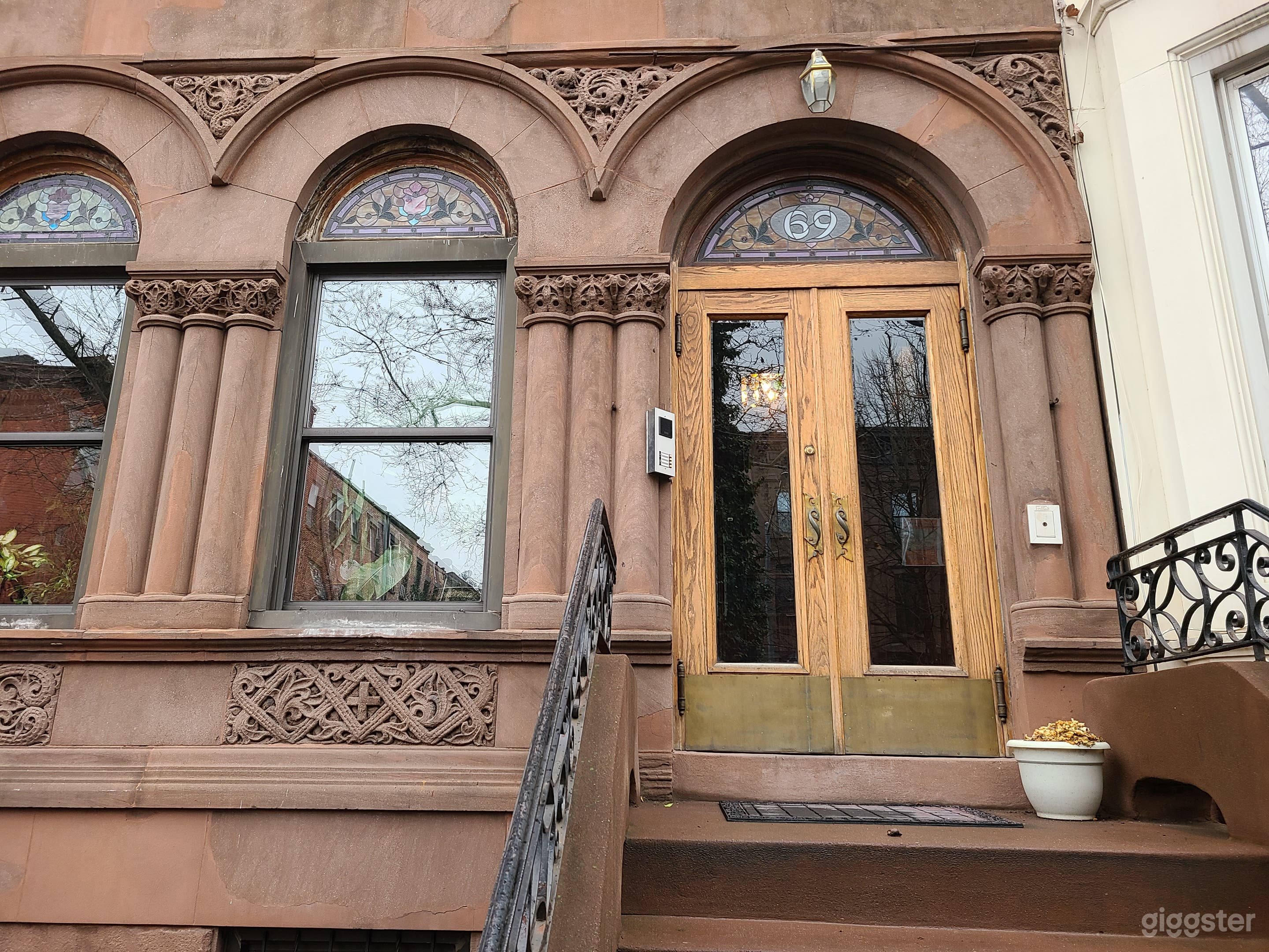 Beautiful Entryway with ornate carved details. Stained glass above doorway and windows.
