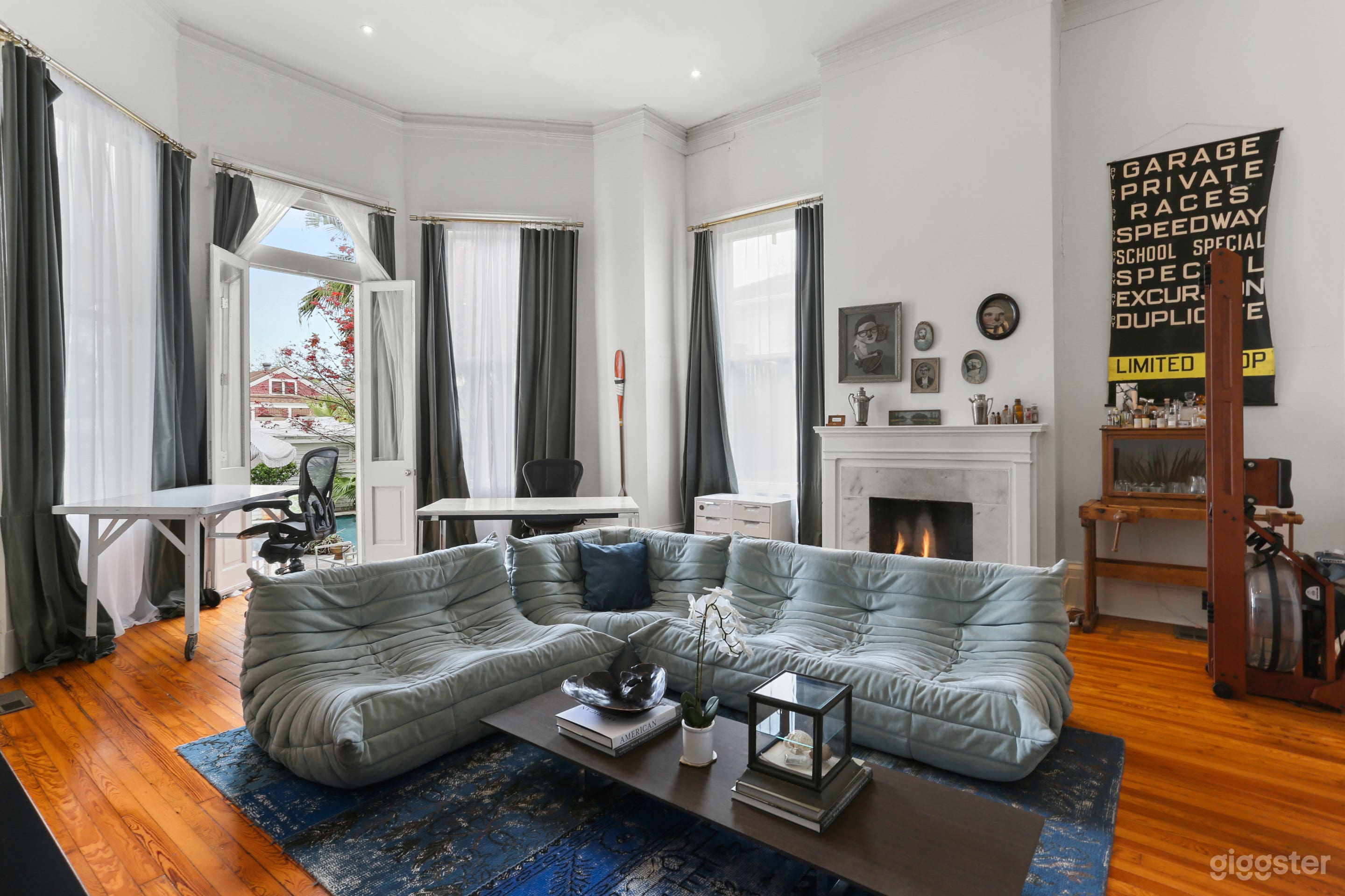 Step into this stunning room off the ballroom, showcasing high ceilings, a cozy fireplace, and floor-to-ceiling windows that flood the space with natural light—an ideal backdrop for sophisticated New Orleans celebrations.