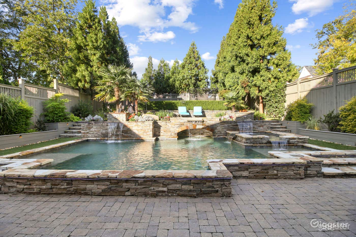 Pool and backyard are surrounded by greenery for privacy and a nature-filled backdrop