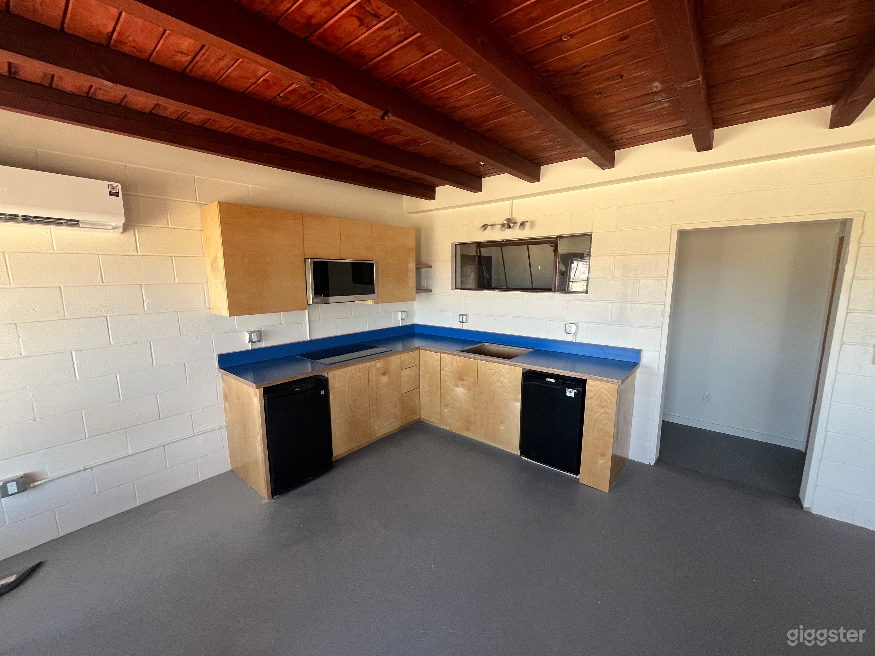 Open kitchen with microwave/convection oven, electric stovetop, fridge/freezer, stainless steel sink