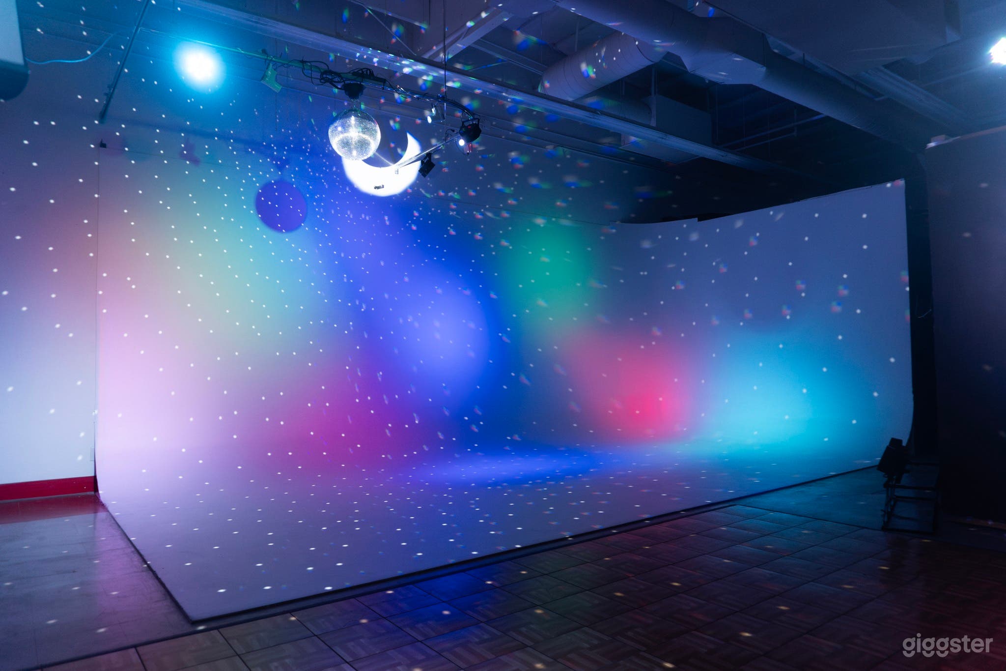 Our 25'x12' cyclorama with stage and disco lighting.