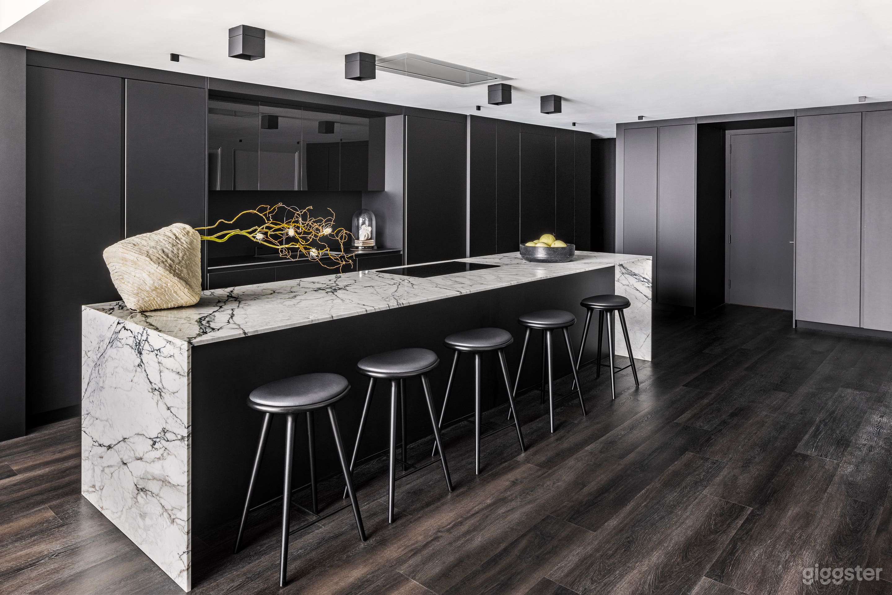 Black kitchen with large marble island 