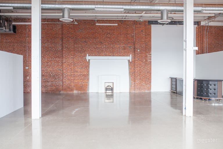  14 ft ceilings, exposed brick, beams, polished concrete floors, open concept floor plan, bar and fireplace mantle (can be removed for a fee) 