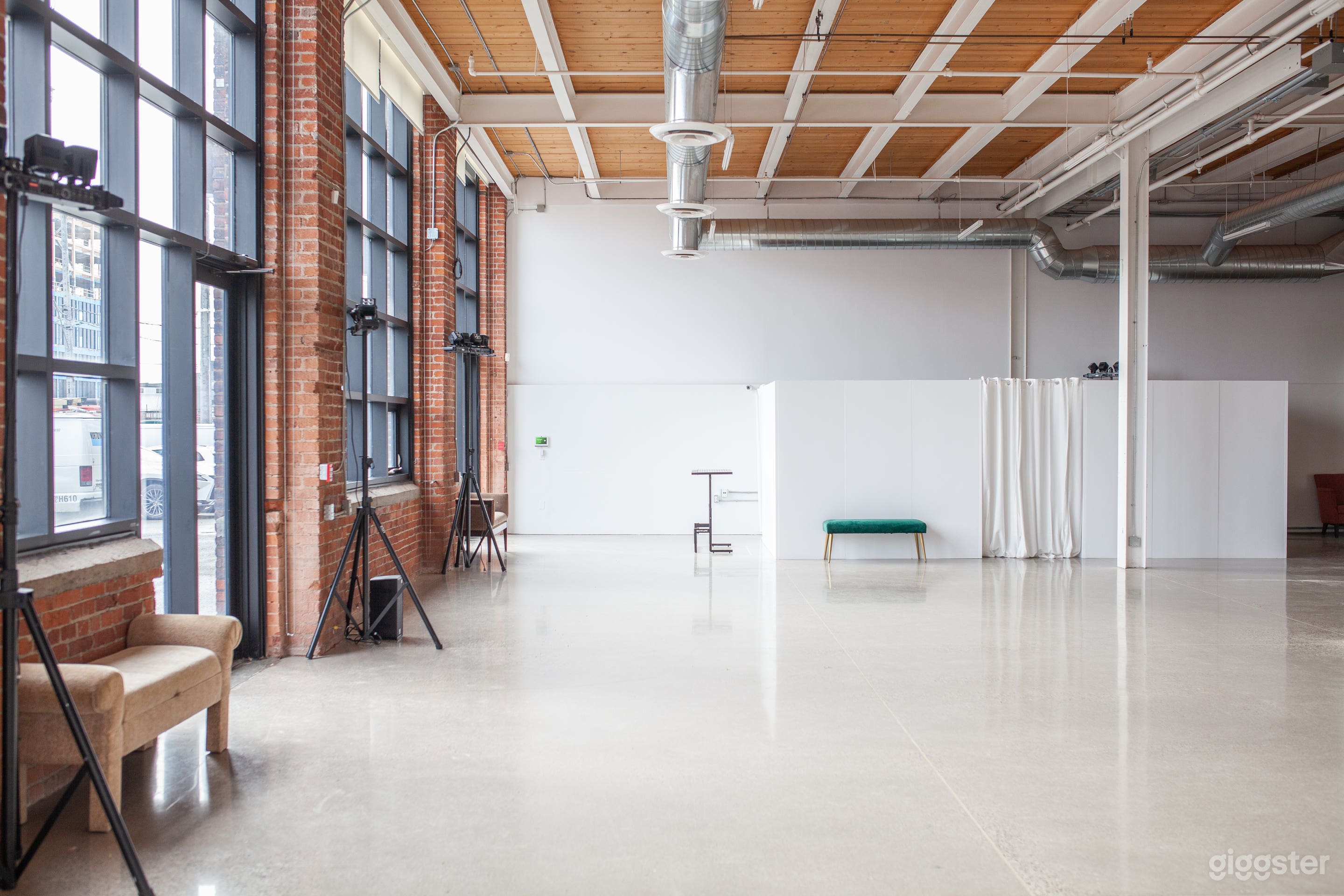 14 ft ceilings, 12 ft windows, exposed brick, beams, polished concrete floors, open concept floor plan