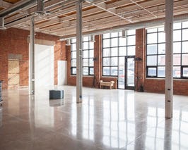  14 ft ceilings, 12 ft windows, exposed brick, beams, polished concrete floors, open concept floor plan 