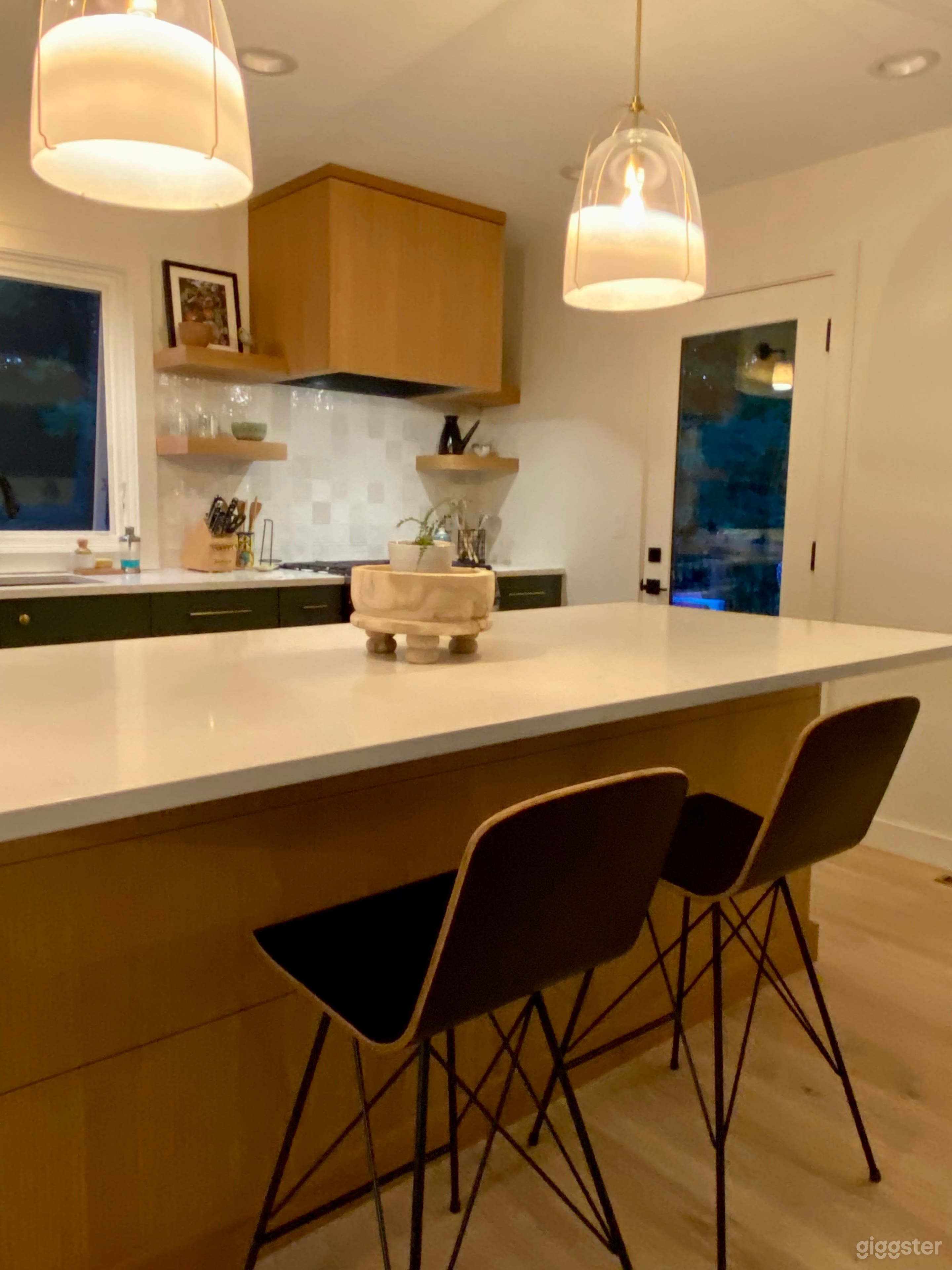 Large kitchen white oak island with white quart countertops