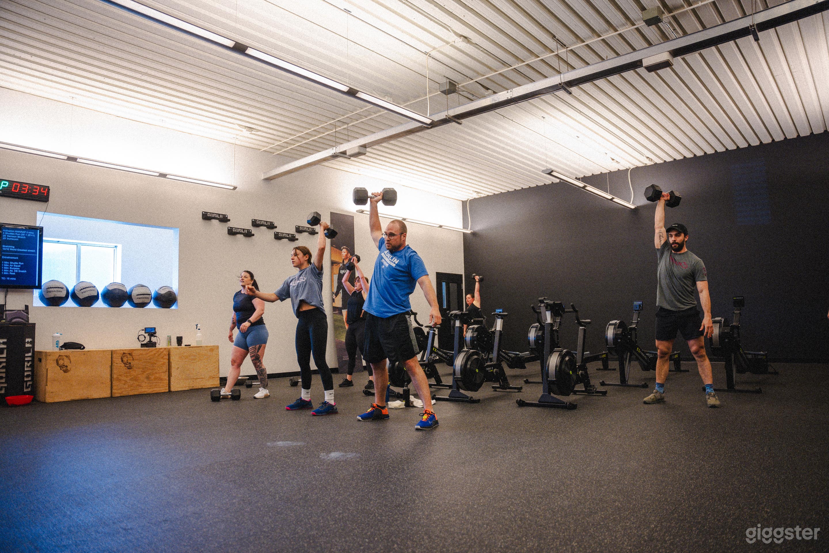 Cardio equipment are stored on the wall, leaving plenty of space in the center of the gym.