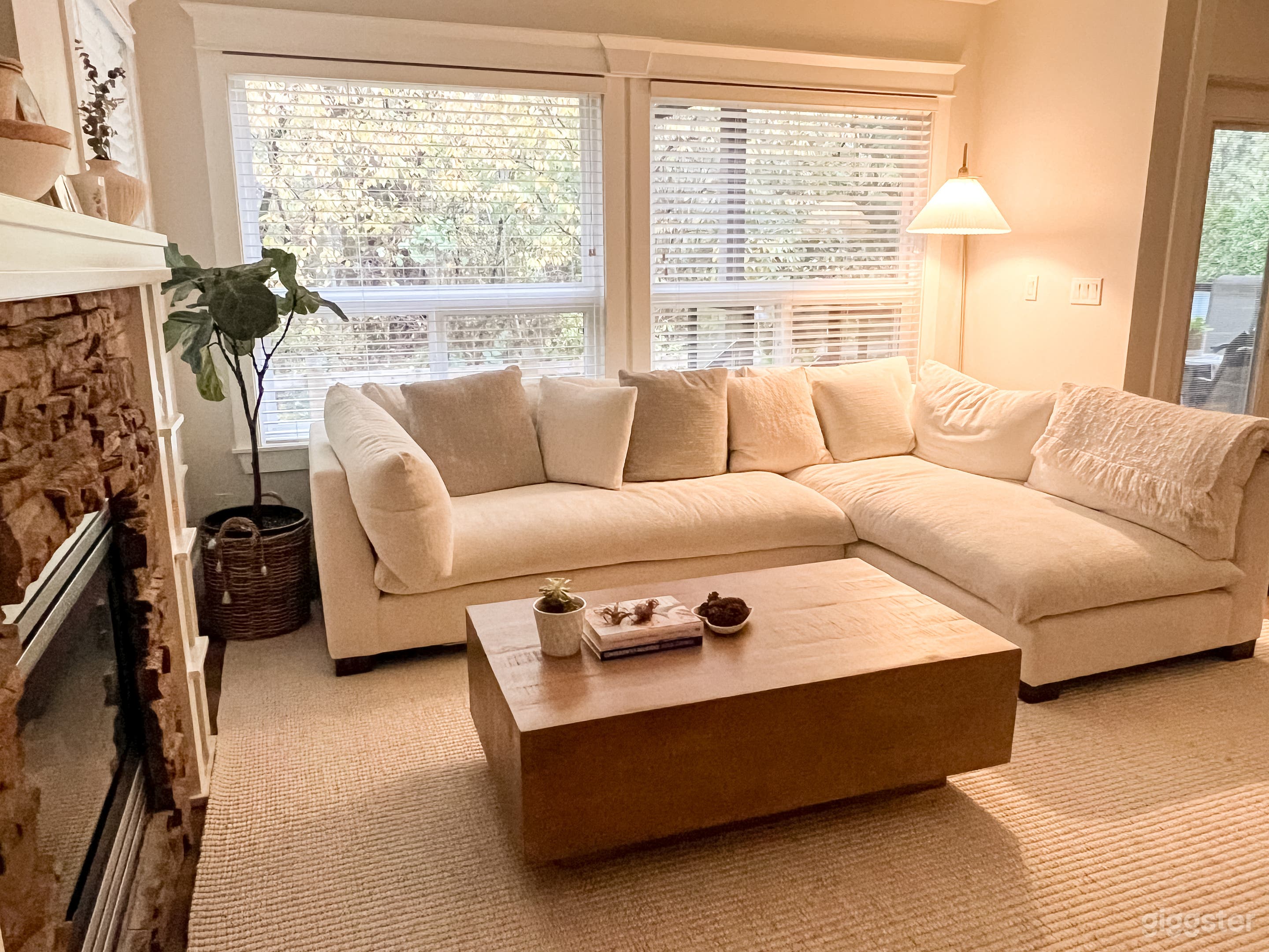 Bright Scandinavian-style living room with a cozy sectional, natural wood accents, and soft neutral tones.